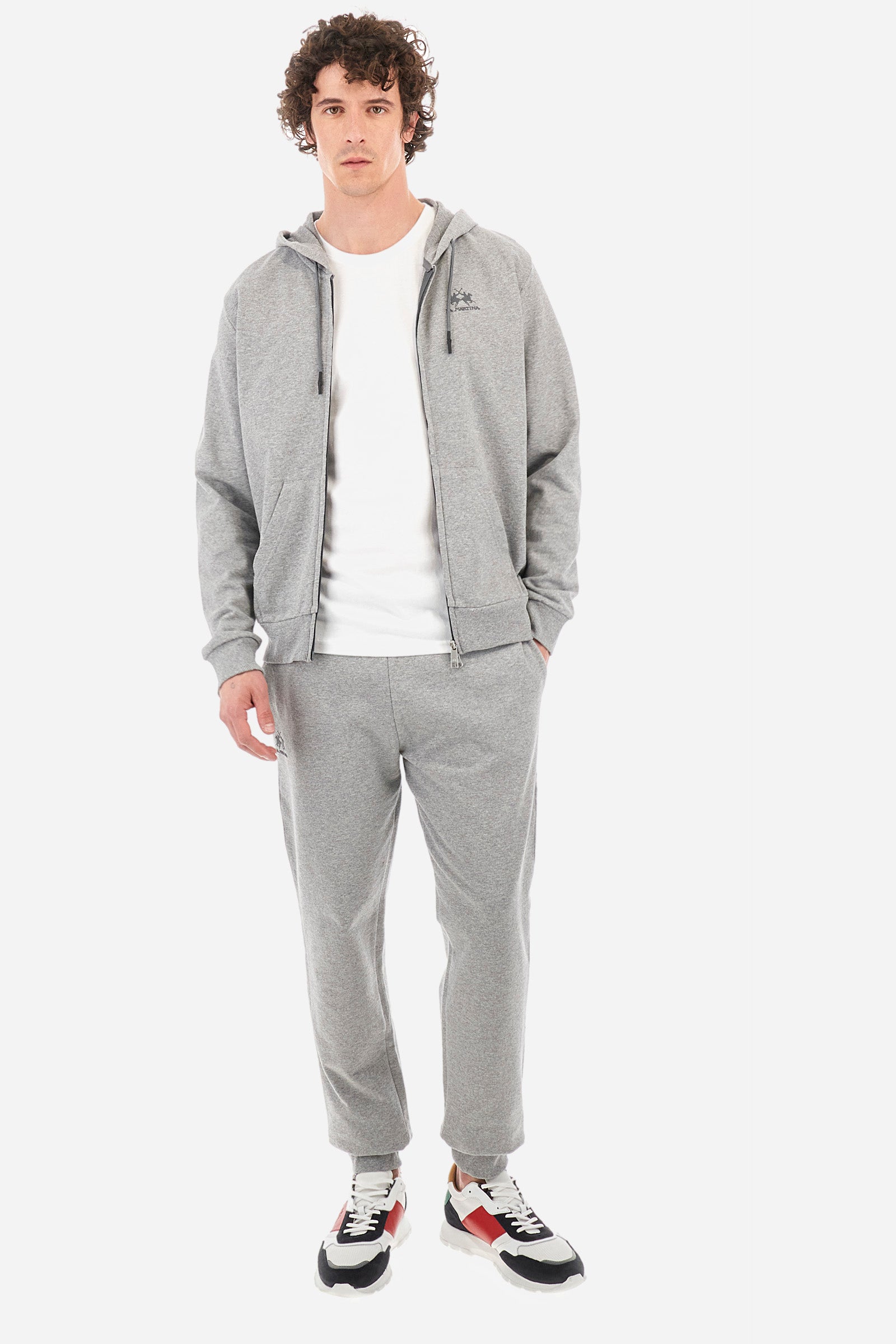 Men's short-sleeved crew-neck T-shirt in solid colour with embroidered logo in contrasting colour on the chest. Made of 100% cotton with a regular fit. It is perfect paired with Bermuda shorts or trousers for a casual and trendy look. Suitable for leisure time. The model is 187 cm tall and wears a size L. - Optic White