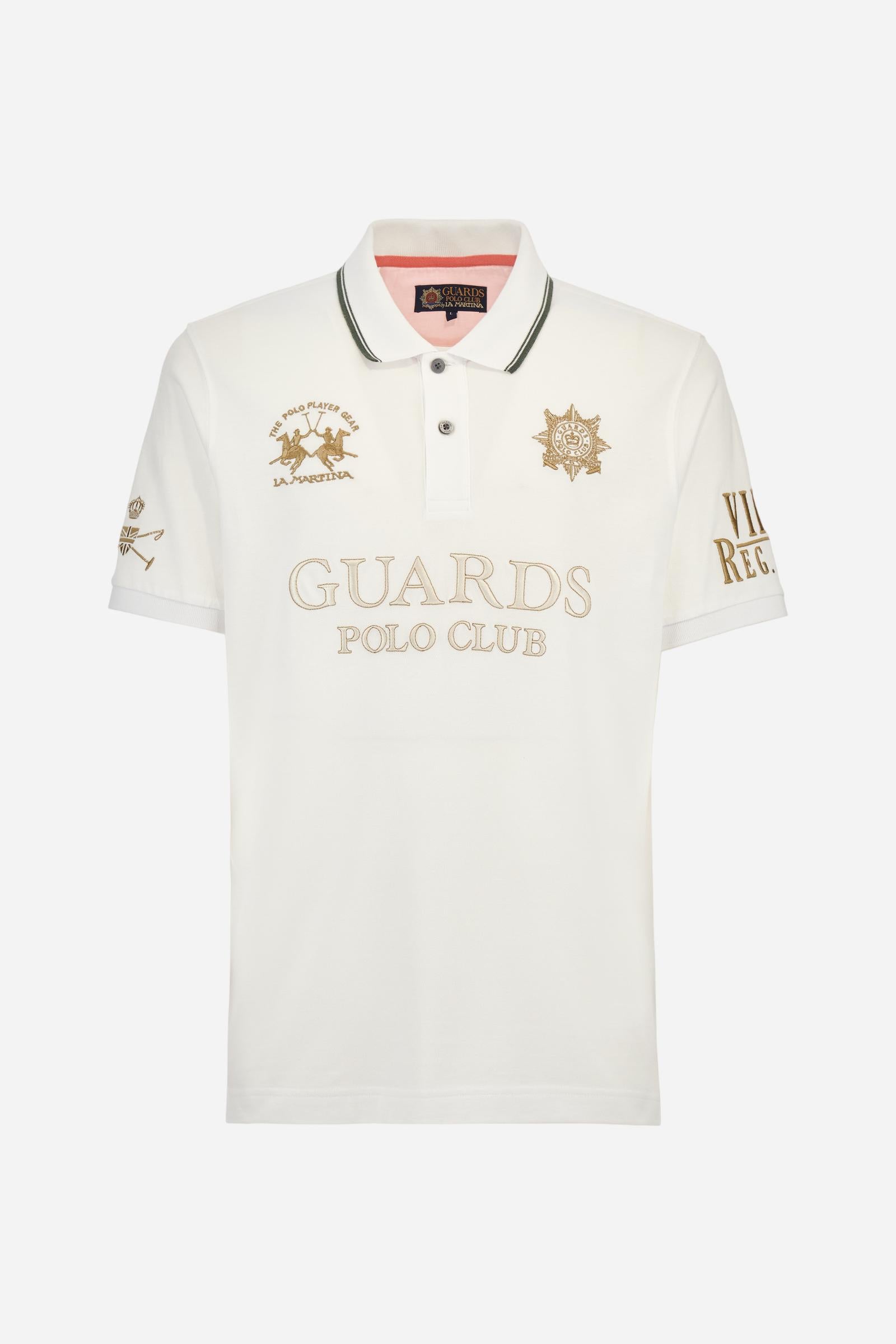 Men's short-sleeved Guards polo shirt in a single colour, made of cotton piqué. Fastens with two buttons. The collar is ribbed with striped trim in a contrasting colour. The graphics on the chest and sleeves are all made using the embroidery technique. The central lettering on the chest is a 3D embroidery in the same colour as the base fabric. The large colour-contrasting logo is embroidered on the chest. The fit is regular. The model is wearing a size L. - Optic White