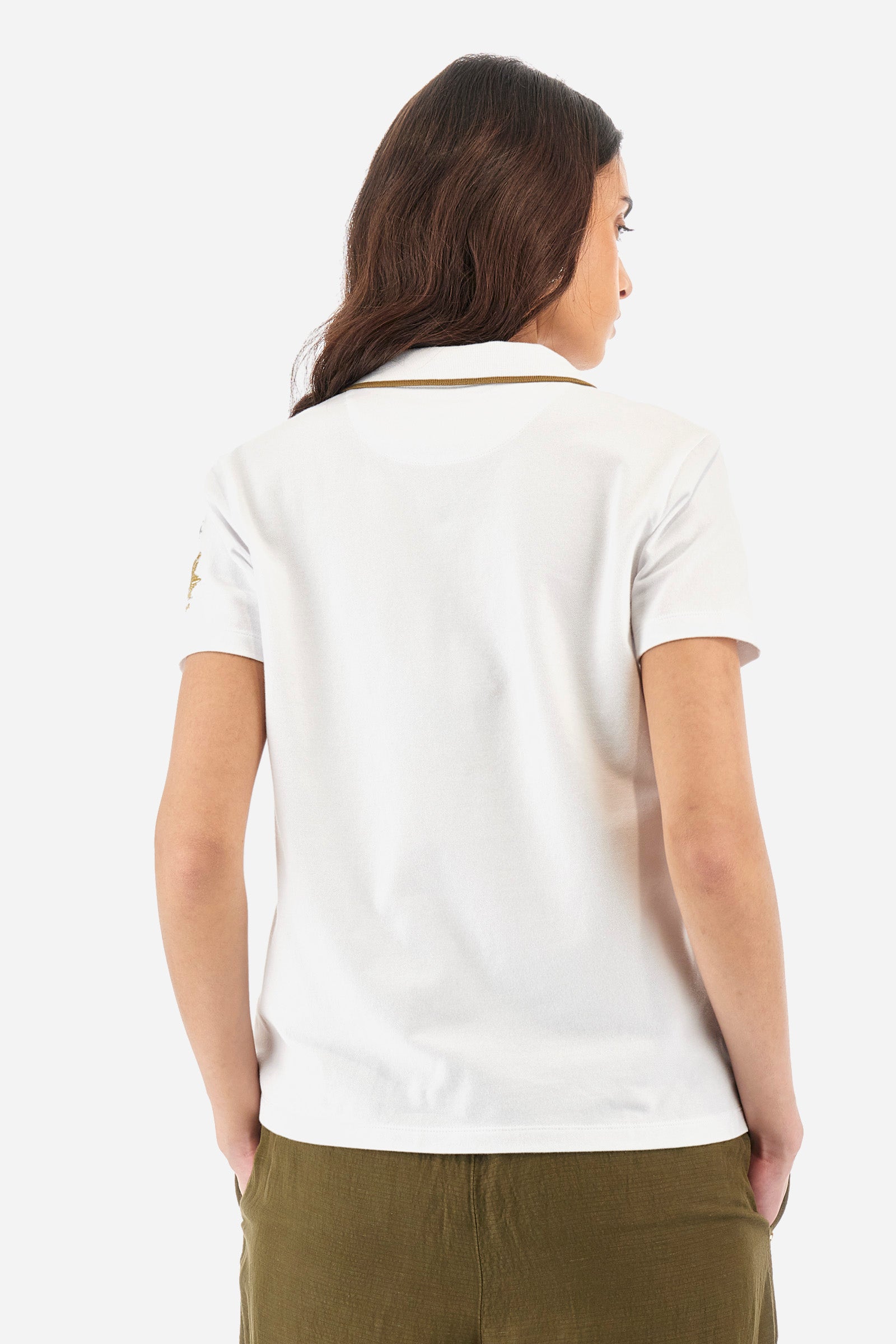Women’s polo with short sleeves in solid color from the Guards line. Made of stretch cotton. V-neck and 2-button jewel closure. Ribbed collar. Side slits. Rhinestones of various shapes, sizes and colors were applied to the front. The logo and the characteristic symbol of the line are embroidered on a sleeve. The fit is regular. The model wears a size 2 . - Optic White
