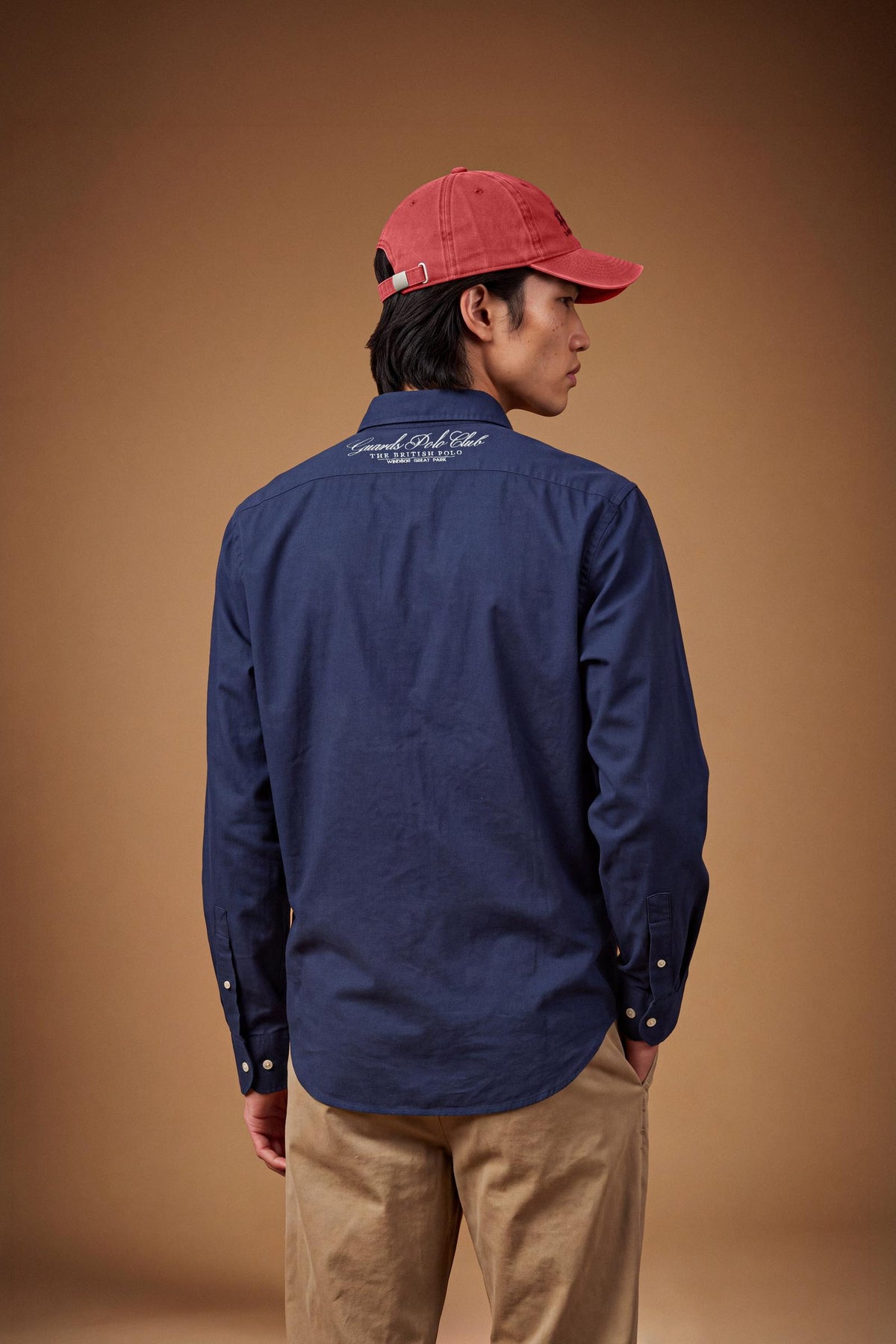 Men’s long-sleeve 100% cotton Oxford shirt with classic collar, button closure, embroidered details, red contrast stitching, and a comfortable regular fit with rounded hem. - Navy