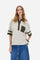 Women’s short-sleeve polo shirt in high-quality solid-colour viscose blend interlock. Classic collar with deep three-button placket, contrast fabric details on body and sleeves. Large embroidered logo on the back. Boxy, straight fit at the hips for a modern and comfortable silhouette. The model wears size L. - Creme Brulè/Kombu Gr