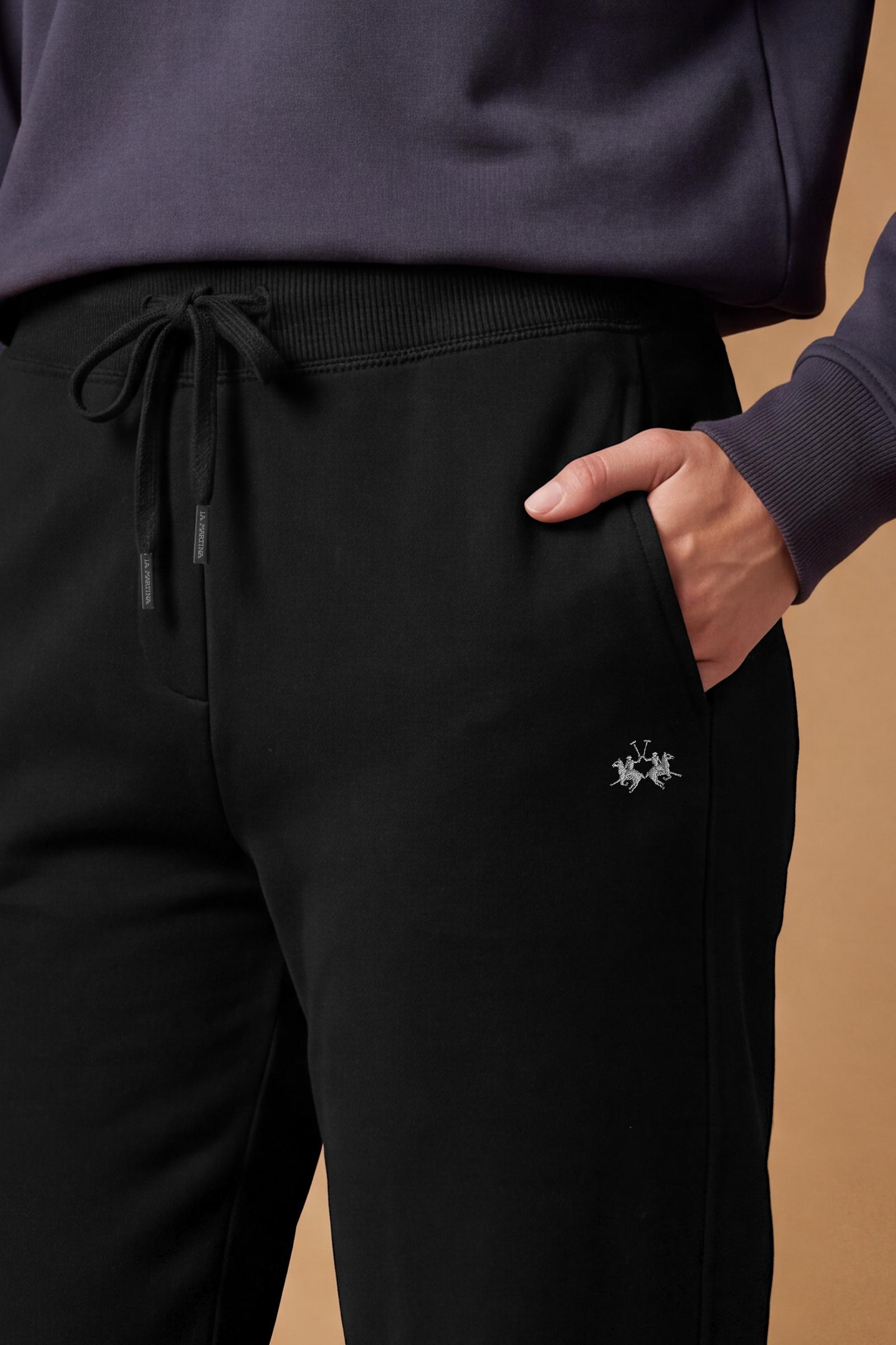 Women's pants in soft brushed cotton with an elastic waistband, adjustable drawstring, vertical side pockets, and a relaxed wide-leg fit for all-day comfort. - Black
