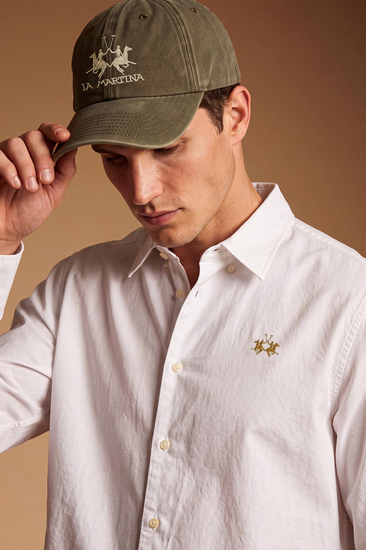 Men’s long-sleeve 100% cotton Oxford shirt with classic collar, button closure, embroidered details, red contrast stitching, and a comfortable regular fit with rounded hem. - Optic White