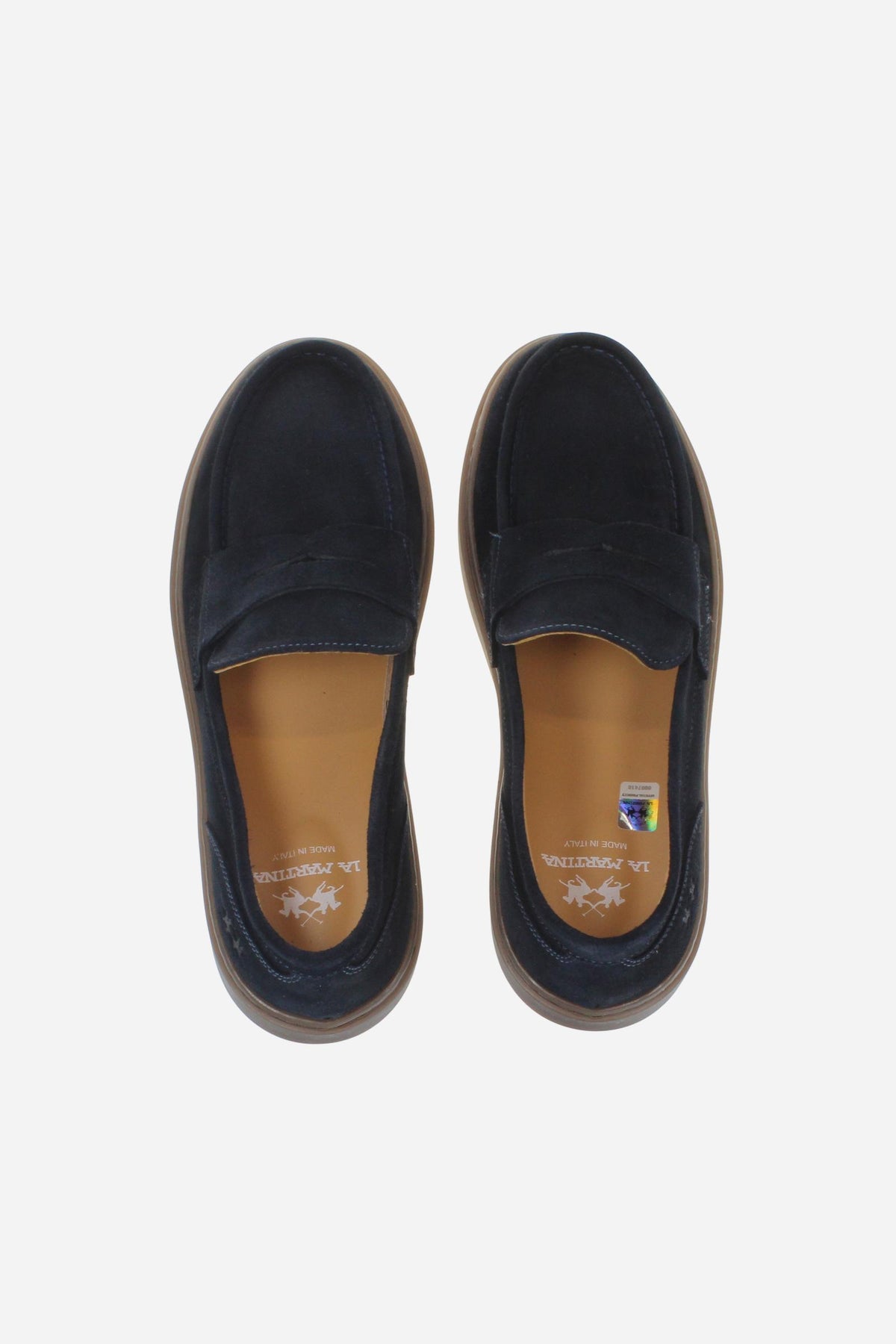 Men's suede loafer with glove stitching, embossed logo, and brown rubber sole for comfort and style. Handcrafted in Italy for casual and semi-formal wear. - Salute