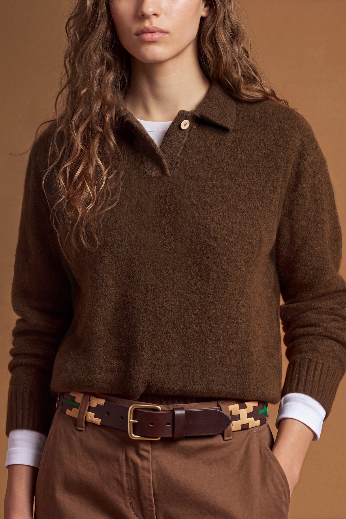 Women's long-sleeve knitted polo in soft lambswool blend, featuring a relaxed cropped fit, ribbed cuffs, shirt-style collar, and smooth, compact knit surface. - Hot Fudge