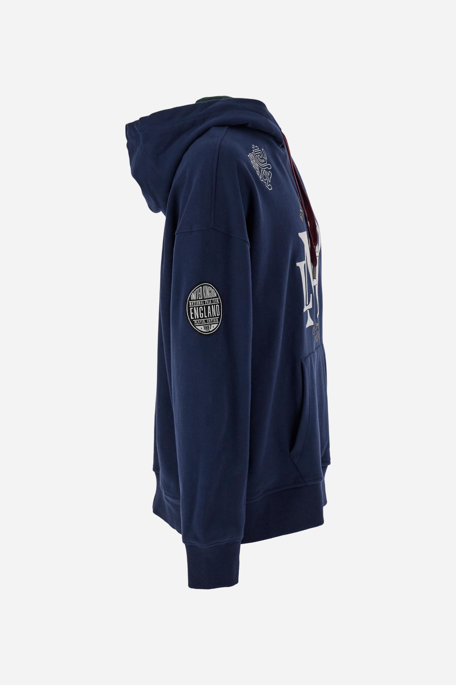 Men's long-sleeved hoodie in solid cotton French terry. Features a large kangaroo pocket, hem and cuffs in tone-on-tone rib. Adjustable hood with contrast lining. Chest and sleeves decorated with modern LM monogram graphics inspired by British polo. Contrasting embroidered logo on the chest. Regular fit for a relaxed and comfortable silhouette. Model wears size L. - Navy