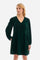 Women's knee-length dress with long sleeves and V-neck on both the front and back. It is made of velvet-effect polyester in a solid colour and features a regular fit, following the England line. The cuff has an elastic band and the side pockets add practicality to the dress. In addition, there is a crown patch logo at the bottom of the dress. Suitable for both the office and more informal occasions. The model is 174 cm tall and wears a size 2. - Cilantro