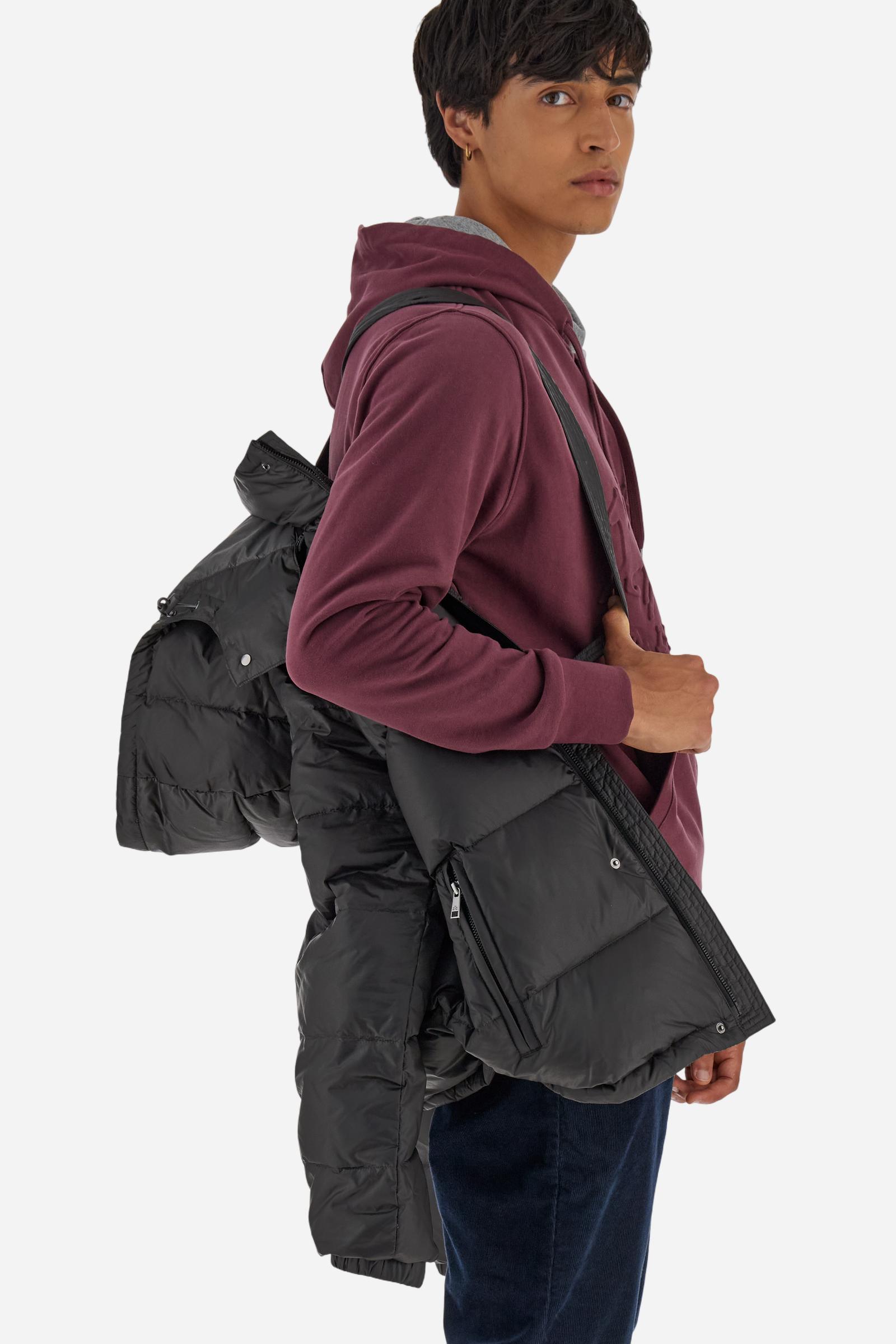 Men’s padded bomber jacket with detachable hood. Made of solid iridescent nylon with contrast lining. Equipped with two practical inner braces for extra comfort. Double customized zip front closure with inner placket featuring contrast Polo Player print, closed with metal snap buttons. Two vertical zipped pockets on the front. Hood with contrast lining and adjustable elastic drawstring. Bold Polo Player graphics printed inside. Regular fit for comfortable movement without bulk. Model wears size L. - Black