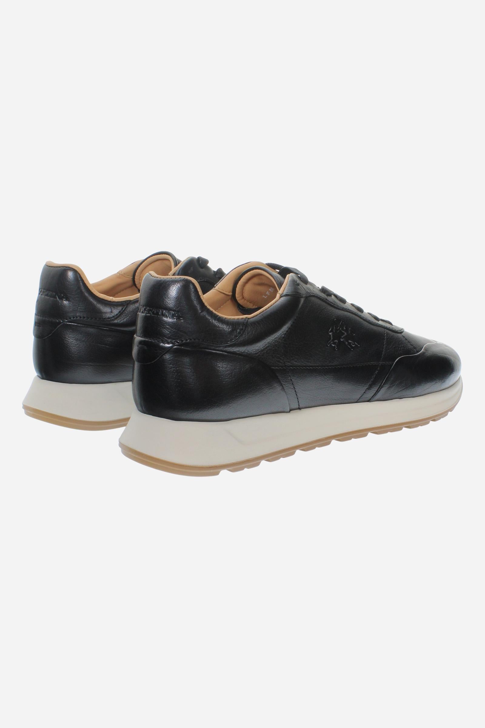 Men's sneaker crafted from soft vegetable-tanned leather with handcrafted stitching, embossed logo, two-tone rubber PU sole, and leather-colored lining. Made in Italy. - Black