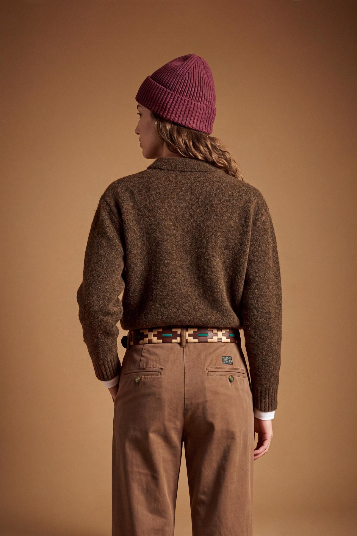 Women's long-sleeve knitted polo in soft lambswool blend, featuring a relaxed cropped fit, ribbed cuffs, shirt-style collar, and smooth, compact knit surface. - Hot Fudge