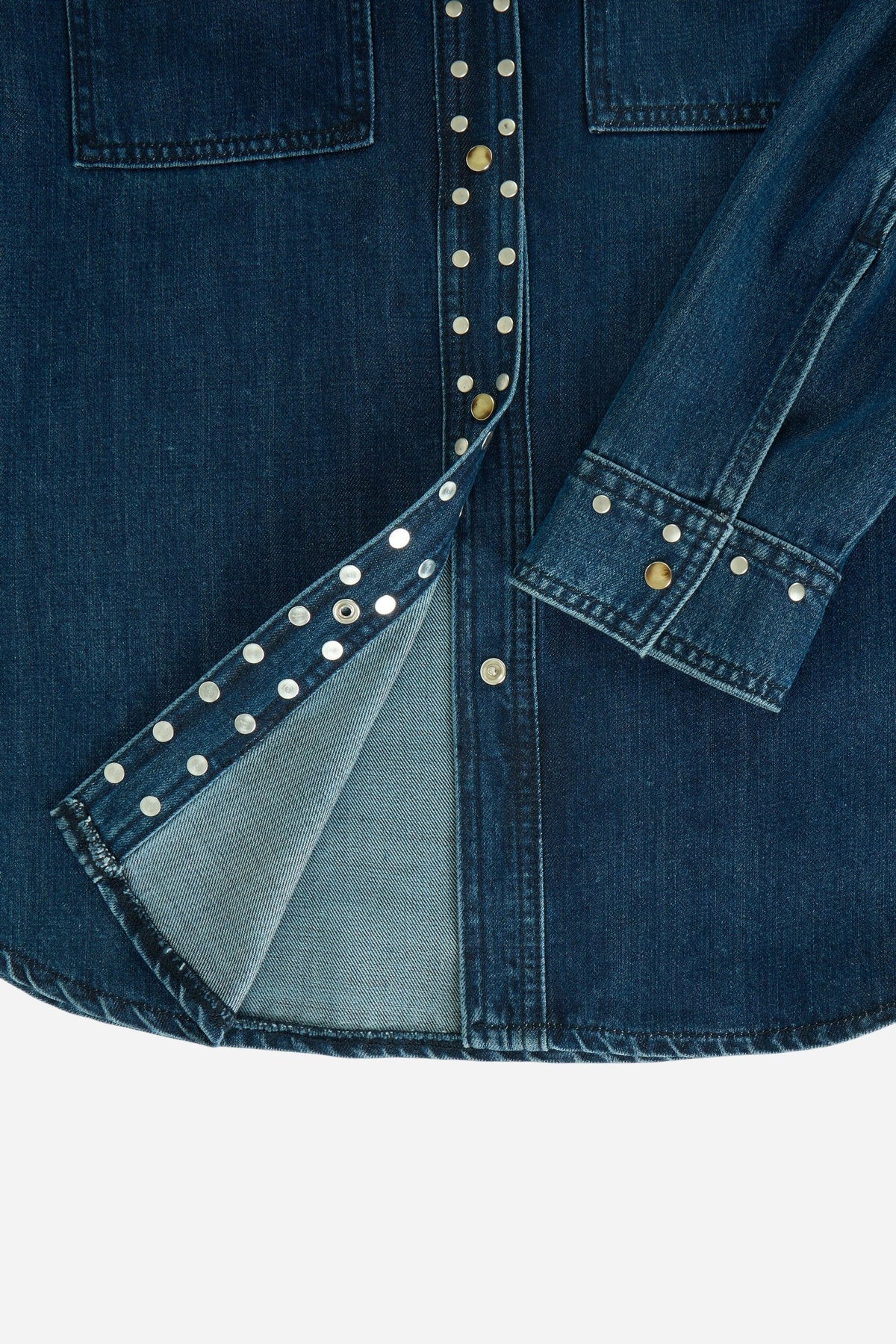 Women's 100% cotton denim shirt with a sturdy structure, dark blue wash, metal rivet details, snap button closure, two flap pockets, and embroidered logo. - Dark Indigo Denim