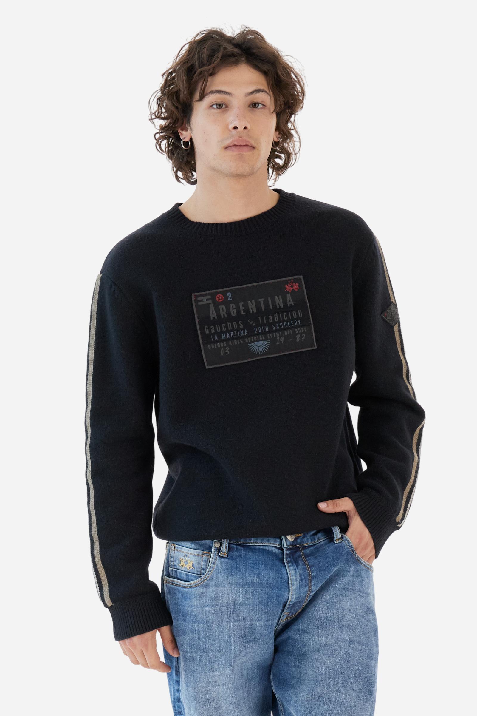 Full-zip men’s sweater in lambswool blend, soft and resistant. Ribbed collar, cuffs, and hem in matching tone. Multicolor striped knitted bands run along the sleeves. A large embroidered patch dedicated to Argentina dominates the chest, complemented by additional embroidered patches on the left sleeve. Relaxed, comfortable fit for distinctive everyday style. Model wears size L. - Black