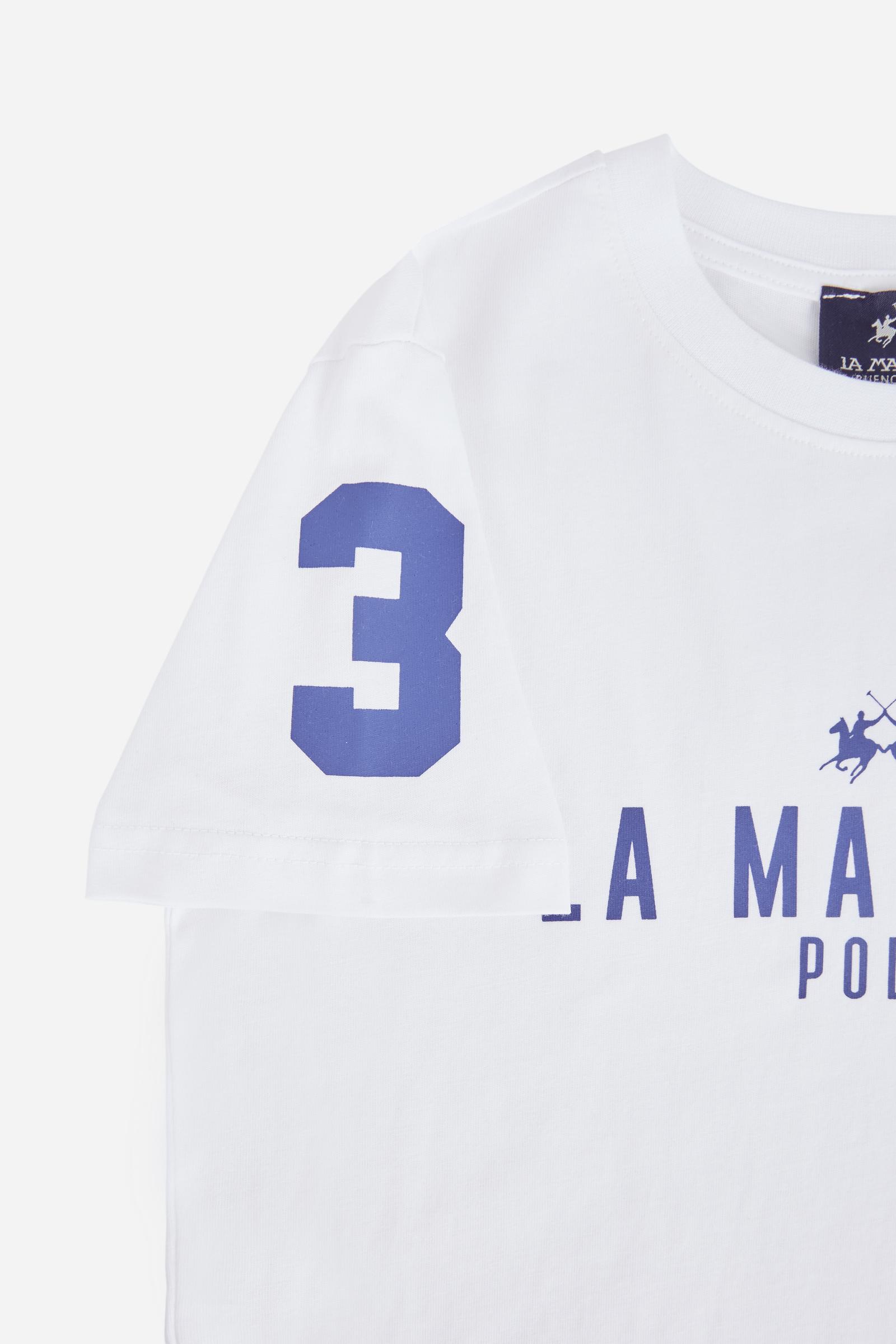 Short-sleeved T-shirt for boys made from 100% cotton jersey in a solid colour. The style features a regular fit, straight line and tonal ribbed crew neck. The brand’s Iconic graphics, printed in contrast on the chest and sleeve, give the garment a sporty and recognisable style. A versatile T-shirt, perfect for completing seasonal casual looks. - Optic White