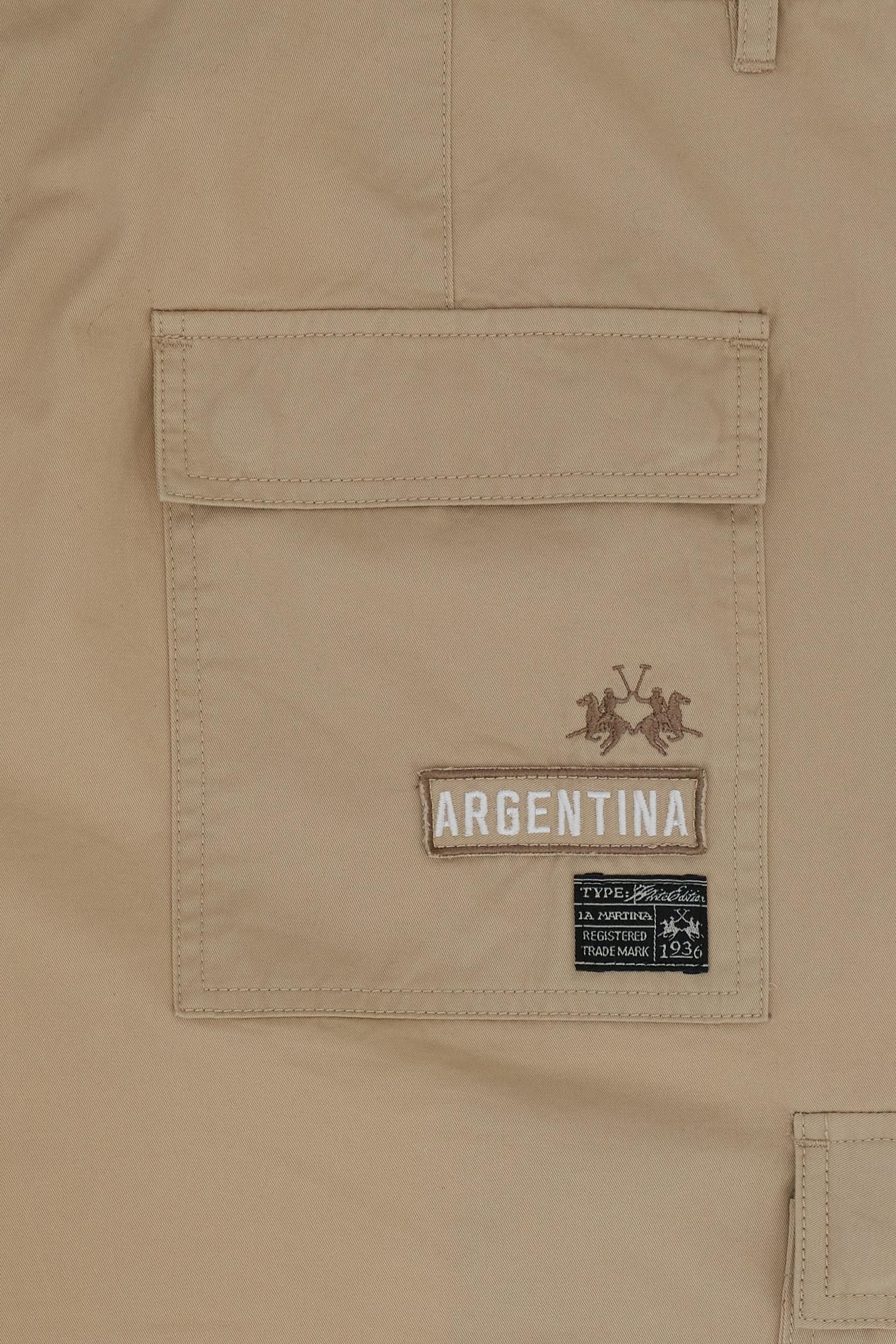 Men's cargo trousers made from 100% cotton twill in solid color. The fabric features a diagonal weave that makes it highly durable yet surprisingly soft to the touch. The regular fit includes a straight leg that slightly tapers toward the hem for a modern silhouette. The waistband features belt loops and a front closure with metal zip and button. The cargo design includes side patch pockets with gussets and flat profile, as well as back patch pockets with flap closure. The garment is finished with the Black