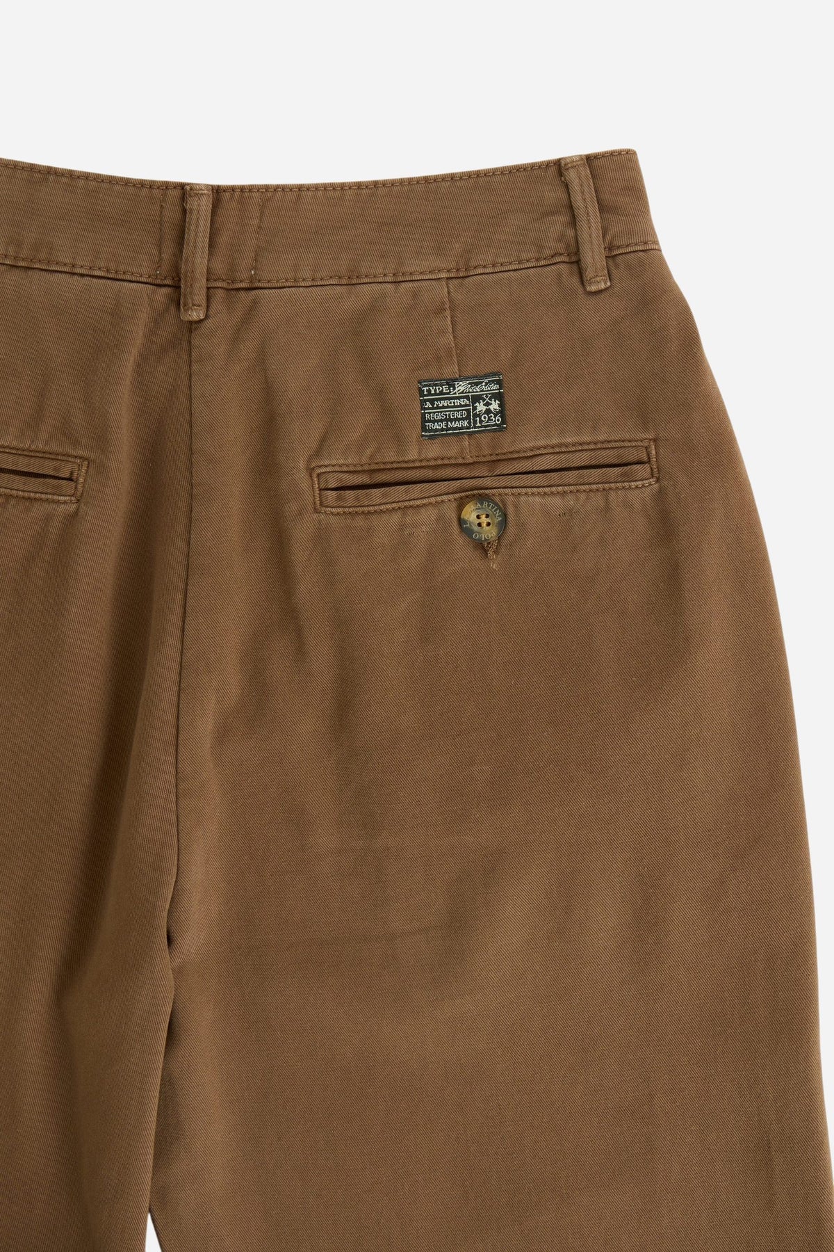 Women’s 100% cotton twill trousers with a regular hip fit, wide flared legs, belt loops, front zipper, button closure, side pockets, and buttoned back pockets. - Carafe