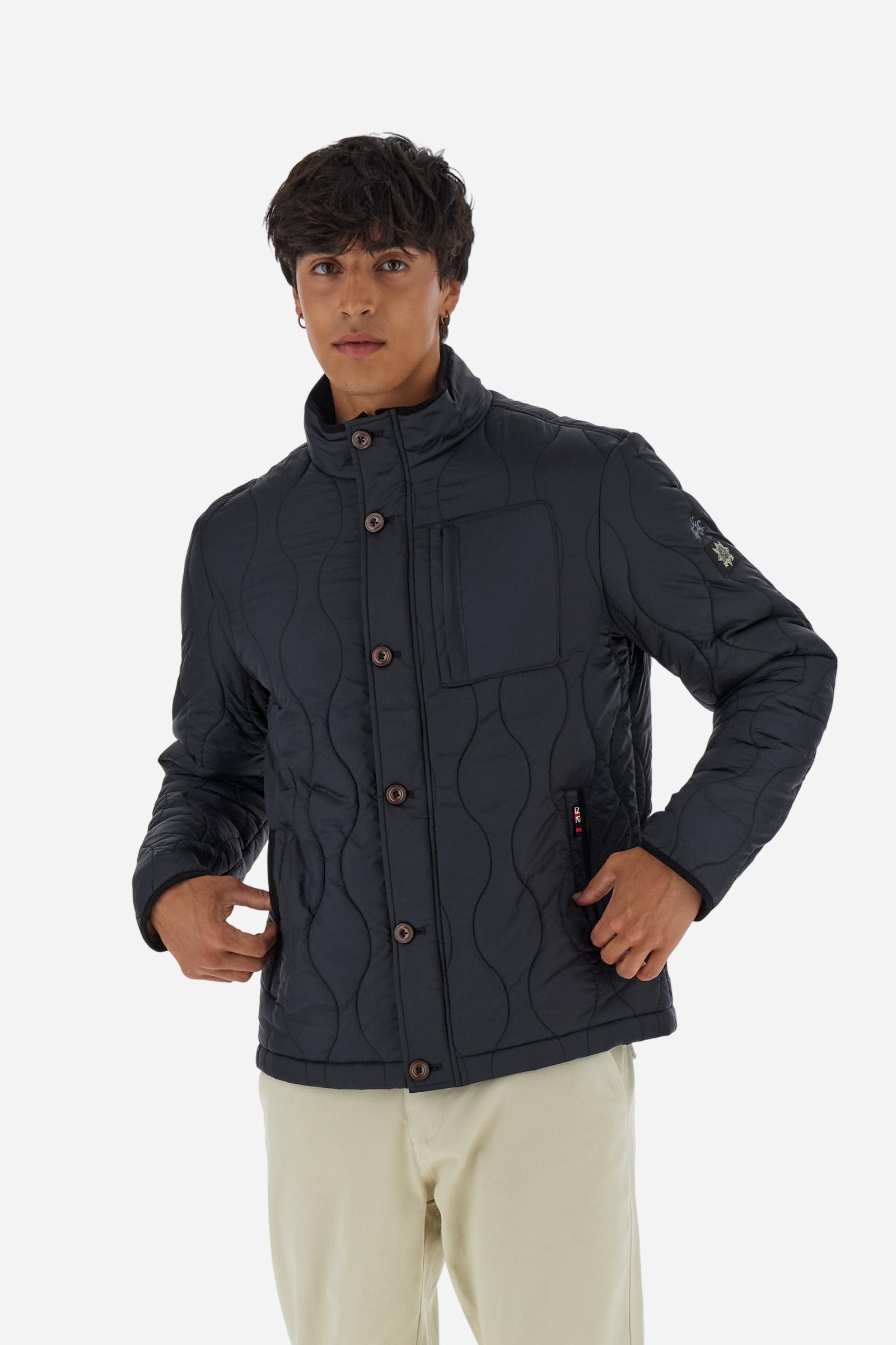 Men’s quilted nylon husky jacket with high collar. Front closure with customized zip and large faux-leather buttons. Interior lined with striped bicolor polyester. Contrast details on the inside (pockets, profiles, back-neck tab). Clean design with chest pocket closed by zip and vertical side pockets. Adjustable back straps with metal snap buttons. Logo patches on the sleeves and multicolor embroidered lettering on the outer collar. Part of the Guards capsule. Regular fit. Model wears size L. - Black