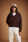 Women's long-sleeve sweater in soft 100% merino wool with a relaxed, slightly oversized fit, V-neck, ribbed cuffs and hem, and a modern cropped length. - Hot Fudge