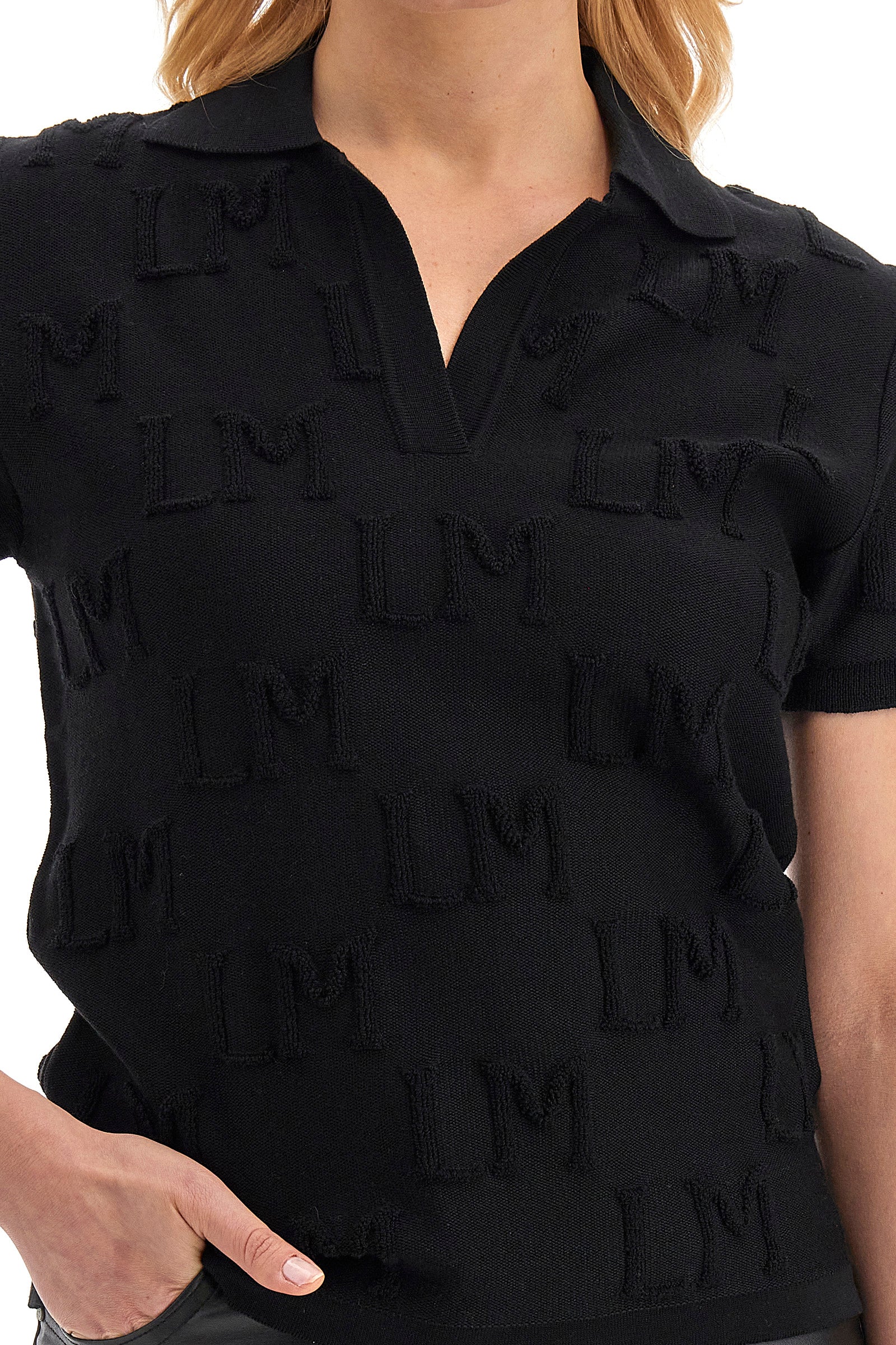 This women's polo shirt is made of 100% wool and features a regular fit. The garment has a solid colour with the LM initial in relief across the whole fabric. The classic V-neck collar completes the elegant and refined look of this polo. Perfect for casual occasions or more formal evenings. The model is 174 cm tall and wears a size 2. - Black