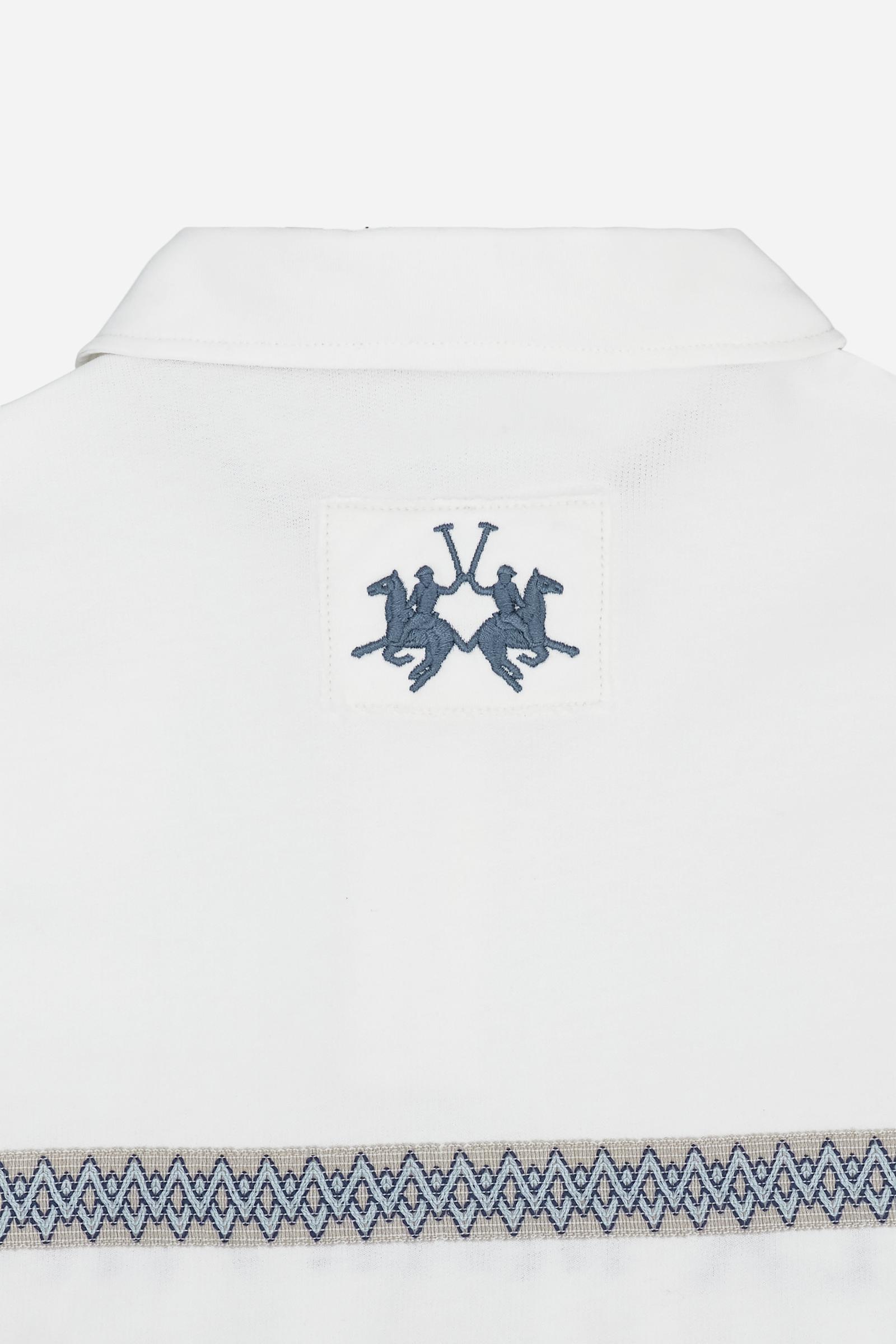 Short-sleeve polo in heavy cotton jersey with a compact structure and substantial hand feel. Contemporary fit with relaxed volume and slightly dropped shoulders. Classic collar with visible placket and bold horizontal band with geometric multicolor tapes. Raised “La Martina” embroidery on the chest and contrasting 3D logo on the back. - Off White                                                                                                                                                                    