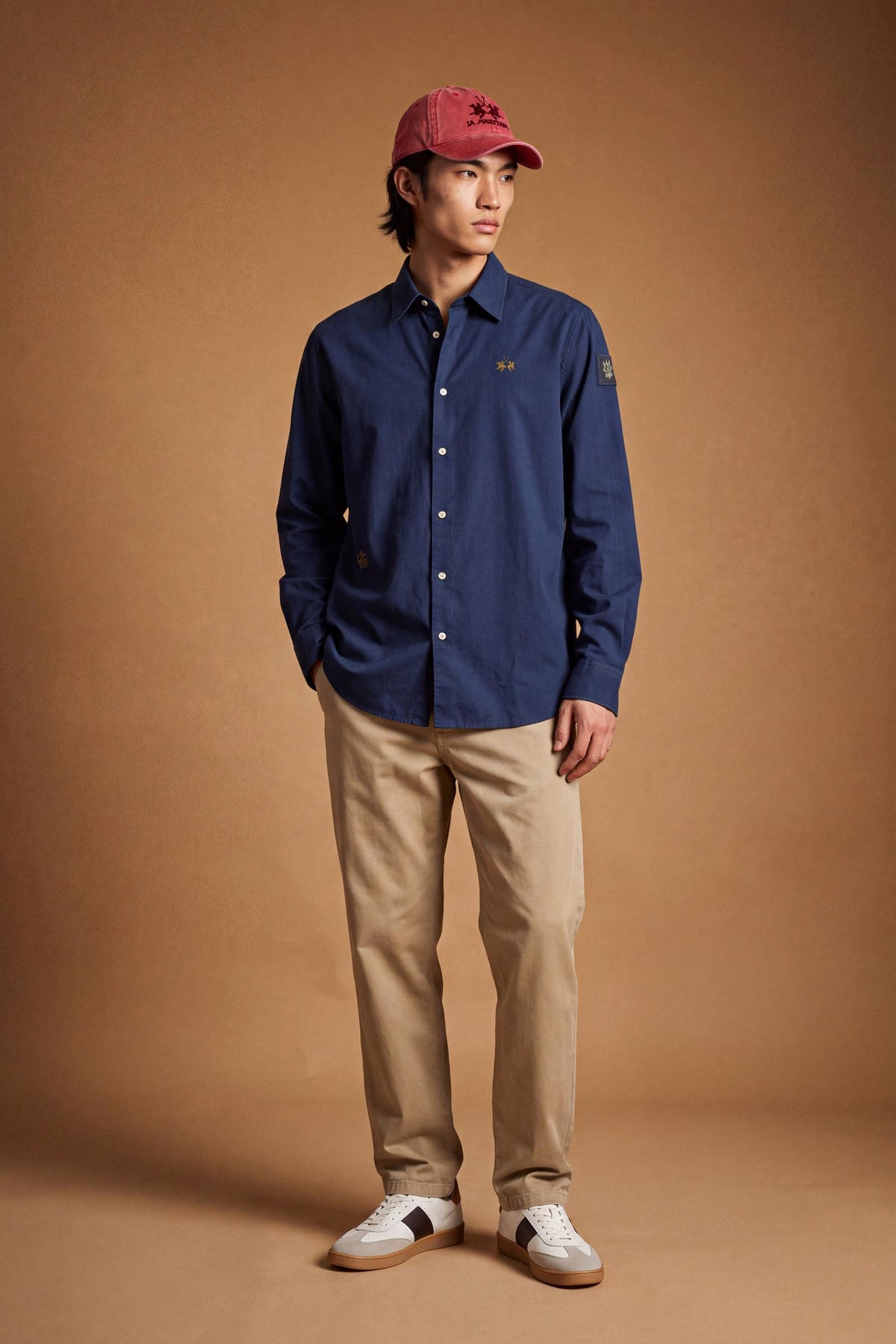 Men’s long-sleeve 100% cotton Oxford shirt with classic collar, button closure, embroidered details, red contrast stitching, and a comfortable regular fit with rounded hem. - Navy