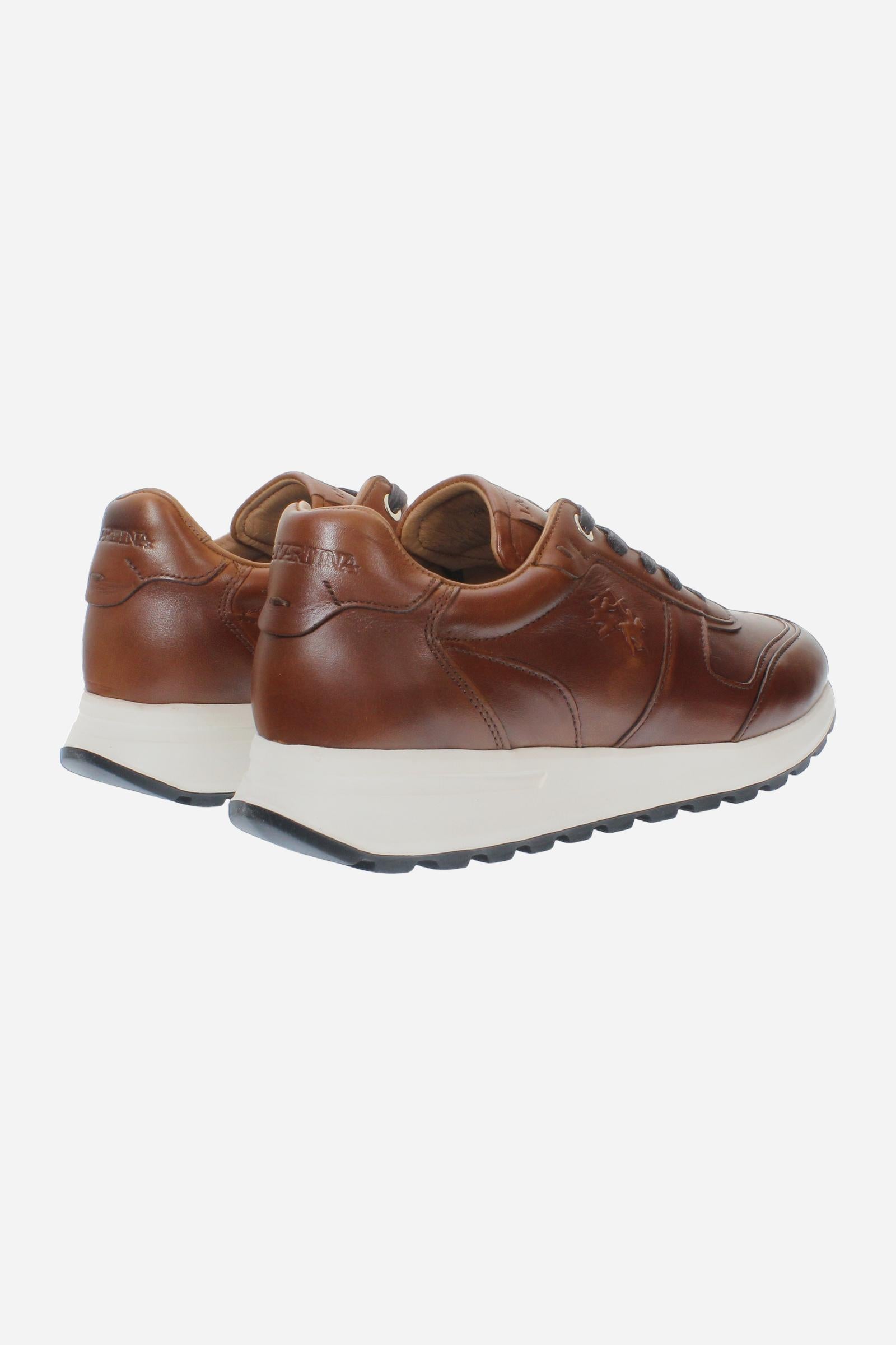 Men's leather sneaker with tone-on-tone stitching, hand-stitched details, embossed logos, and a lightweight two-tone EVA sole for comfort and grip. - COGNAC