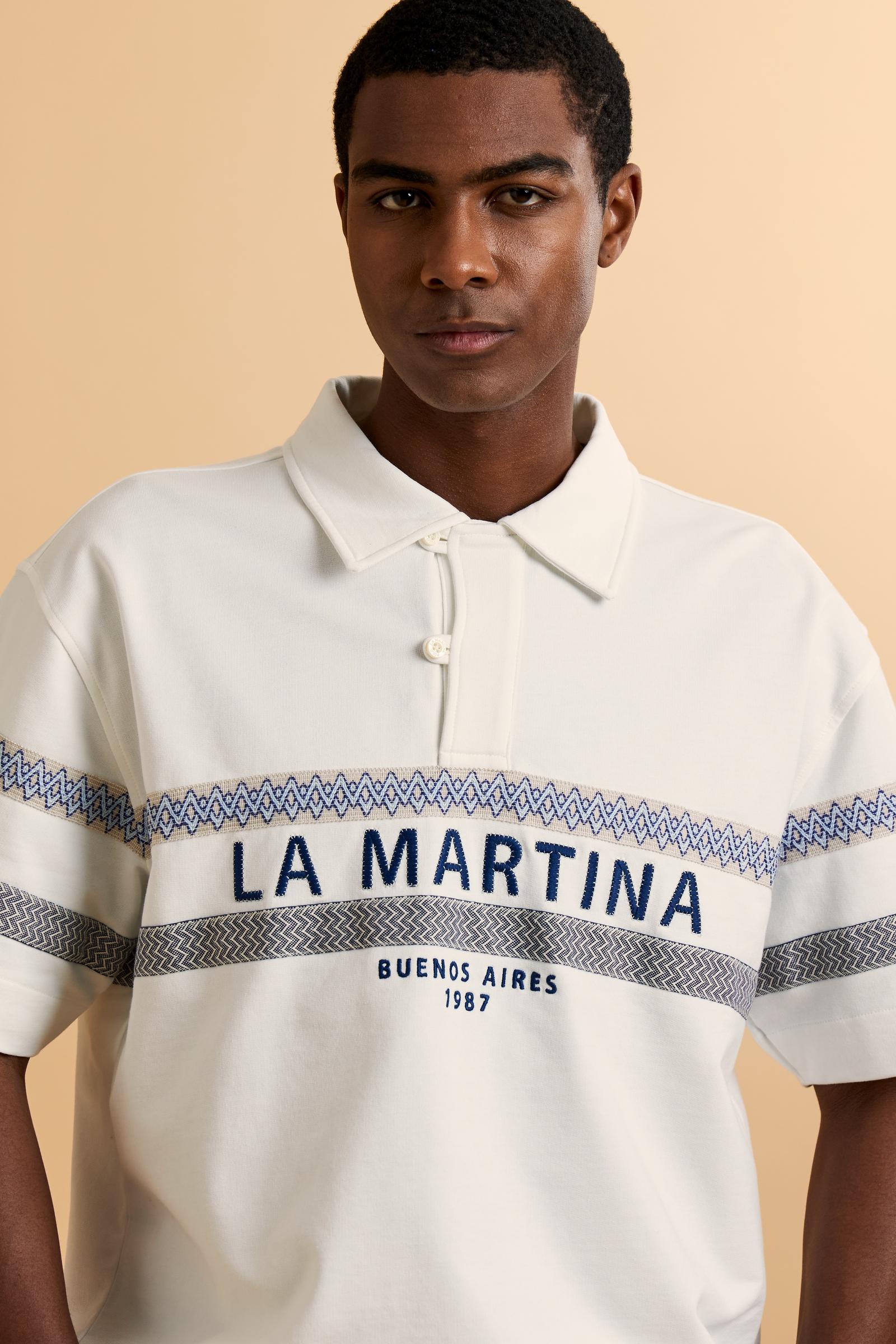 Short-sleeve polo in heavy cotton jersey with a compact structure and substantial hand feel. Contemporary fit with relaxed volume and slightly dropped shoulders. Classic collar with visible placket and bold horizontal band with geometric multicolor tapes. Raised “La Martina” embroidery on the chest and contrasting 3D logo on the back. - Off White                                                                                                                                                                    