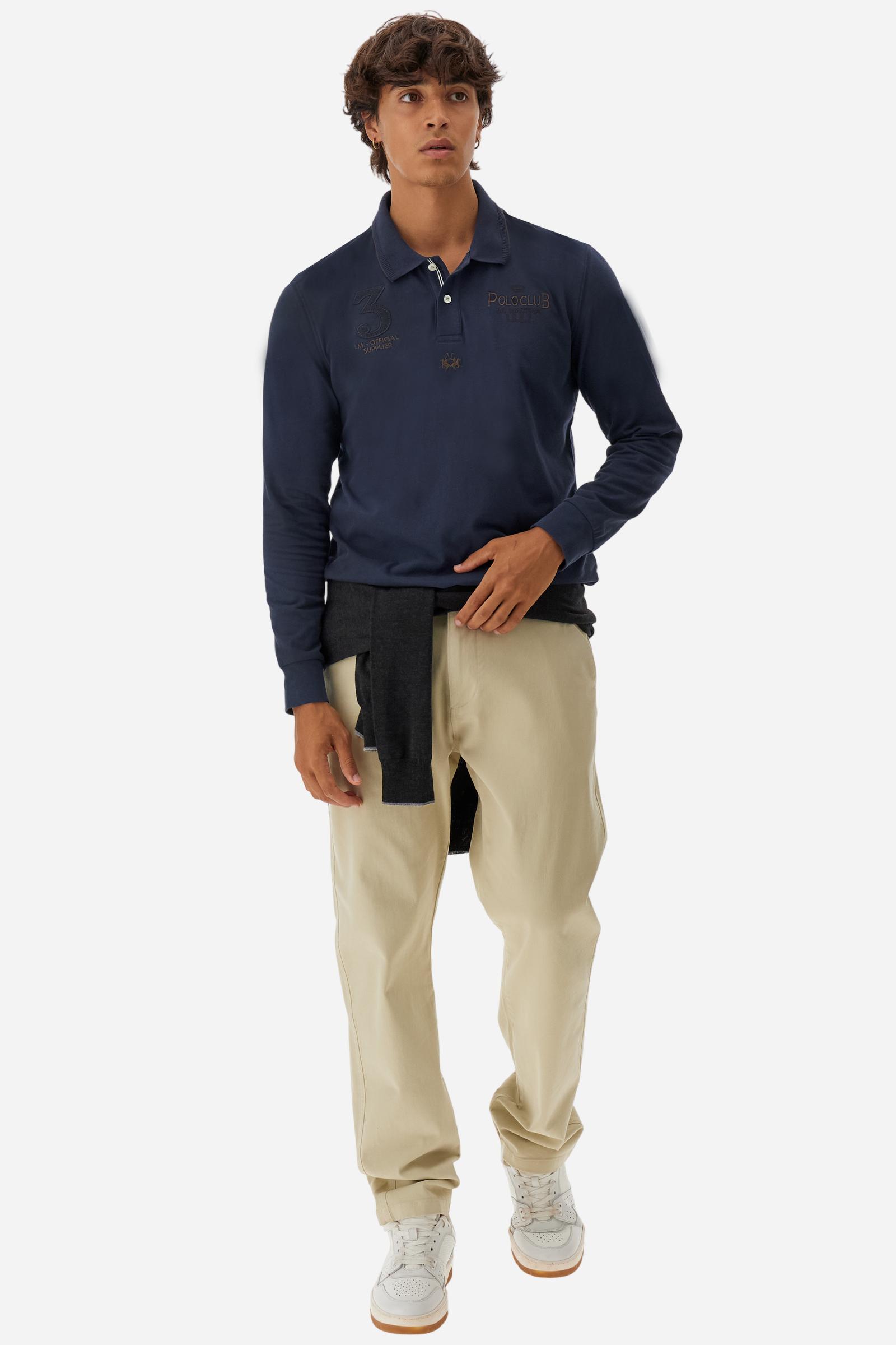 Men’s long-sleeve polo in stretch piqué, solid color. Ribbed collar and cuffs with striped details for a refined touch. Contrast fabric insert under the collar. Chest patch with number 3 and embroidered lettering celebrating the Polo Club. Small brand logo embroidered in contrast under the front placket. Regular fit. Model wears size L. - Navy