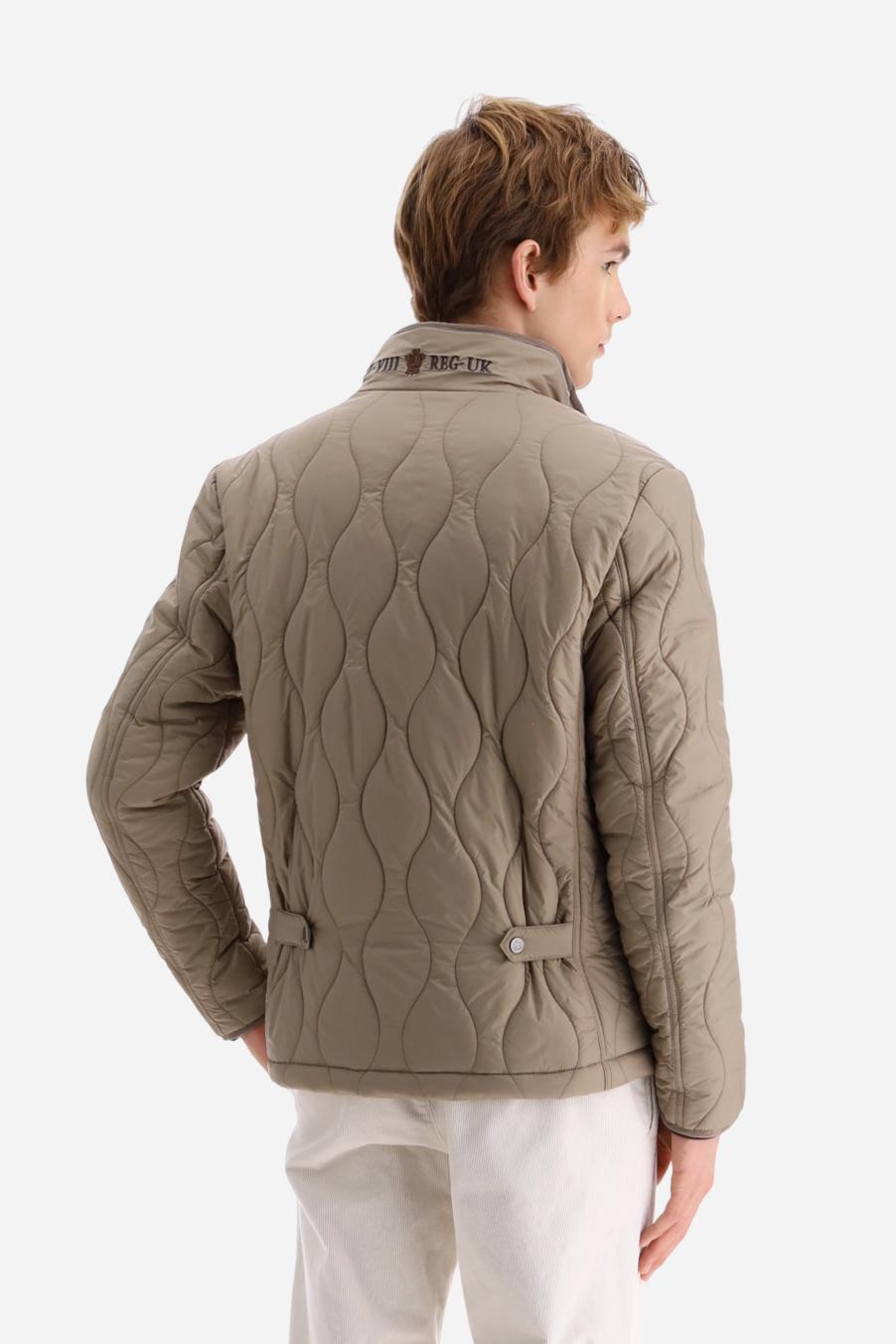 Men’s quilted nylon husky jacket with high collar. Front closure with customized zip and large faux-leather buttons. Interior lined with striped bicolor polyester. Contrast details on the inside (pockets, profiles, back-neck tab). Clean design with chest pocket closed by zip and vertical side pockets. Adjustable back straps with metal snap buttons. Logo patches on the sleeves and multicolor embroidered lettering on the outer collar. Part of the Guards capsule. Regular fit. Model wears size L. - Moon Rock