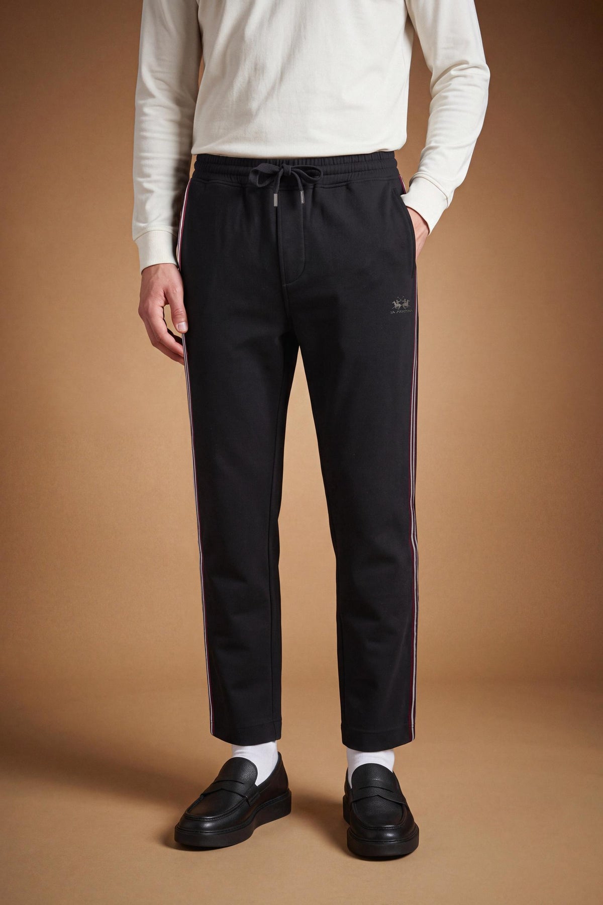 Men's cotton interlock jogging pants with elastic waistband, adjustable drawstring, side and back pockets, multicolored stripes, and a soft, sporty silhouette. - Black