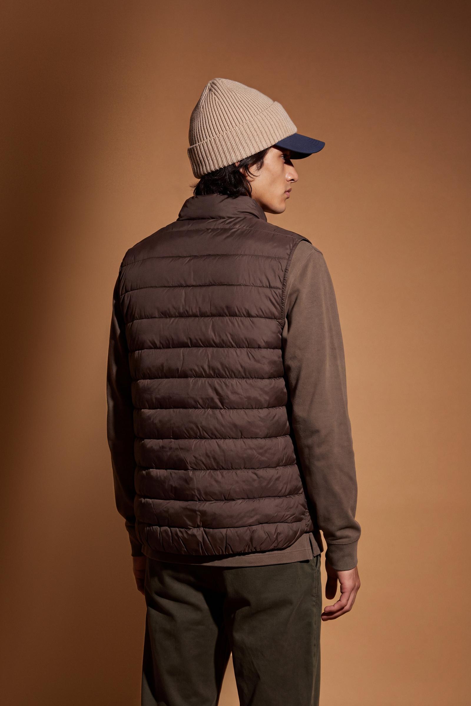 Men's sleeveless down jacket in lightweight nylon with wadding padding for warmth, zippered pockets, high collar, and contrasting interior and logo details. - Hot Fudge