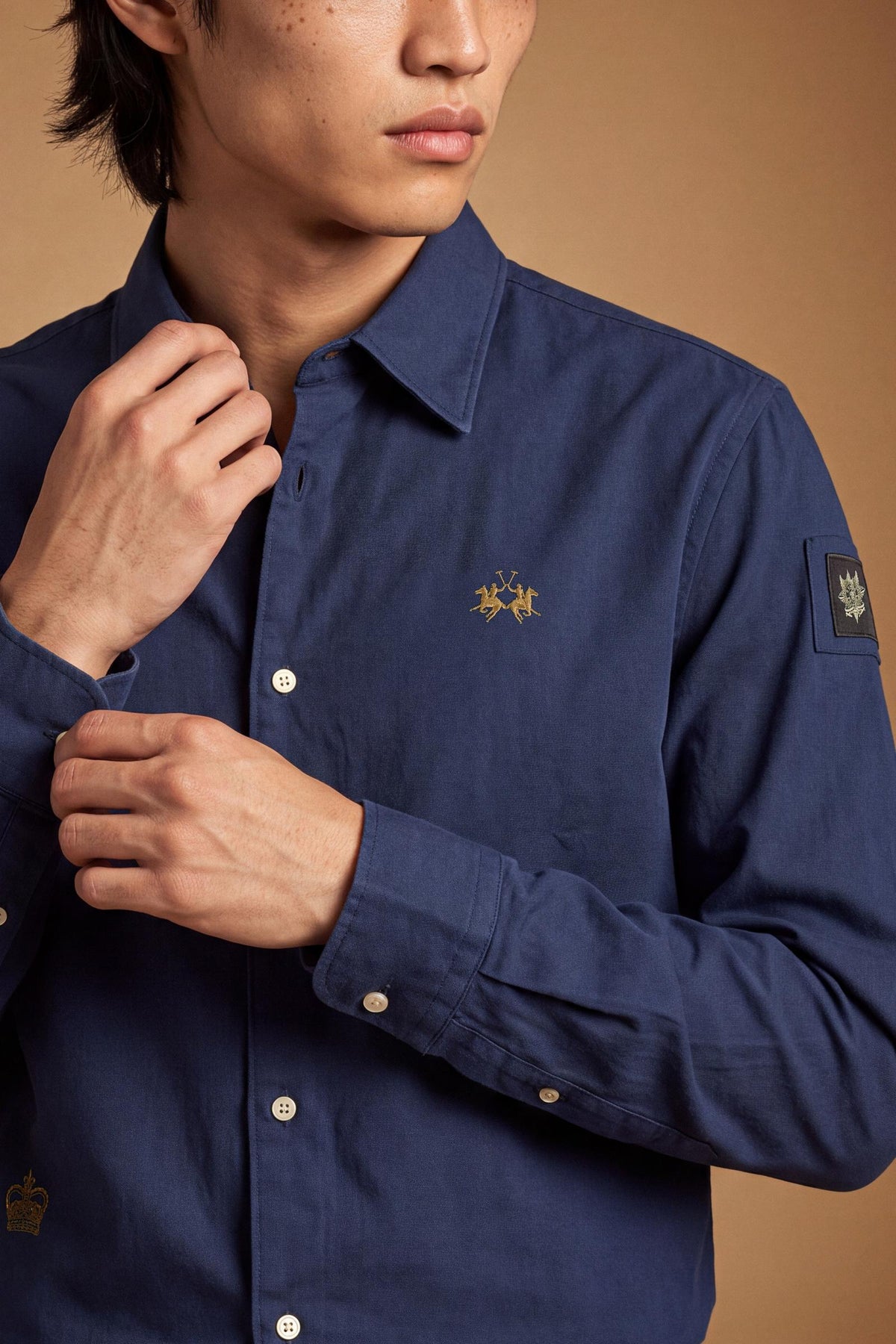 Men’s long-sleeve 100% cotton Oxford shirt with classic collar, button closure, embroidered details, red contrast stitching, and a comfortable regular fit with rounded hem. - Navy