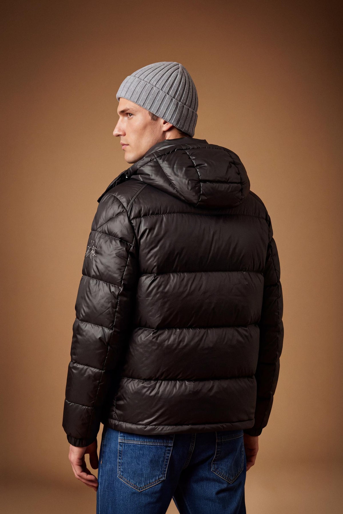 Men's padded feather bomber jacket with detachable hood, iridescent nylon, double zipper, snap buttons, adjustable drawstring, zippered pockets, and embroidered logo. - Black