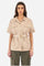 Short-sleeved jacket in solid color, made of 100% cotton twill. French collar. Buttons as closure along the head and on the two front pockets. Removable fabric belt supplied. Mini patch that recalls the capsule Guards applied on one of the sleeves and a mini logo applied on metal plate. The fit is regular. The model wears a size 2. - Tidal Foam