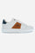 Trainer made of natural tumbled leather, with an exclusive sole in a super light block-colour EVA mix, customised with the La Martina logo on the bottom. The smooth leather trim highlights the shape of the saddle patch, finished with hand-sewn stitching. The contrasting top and side band feature the high-frequency logo on the side, while the La Martina lettering is printed. The eyelets are customised, and every detail reflects the unique craftsmanship of the shoe. - WHITE/COGNAC
