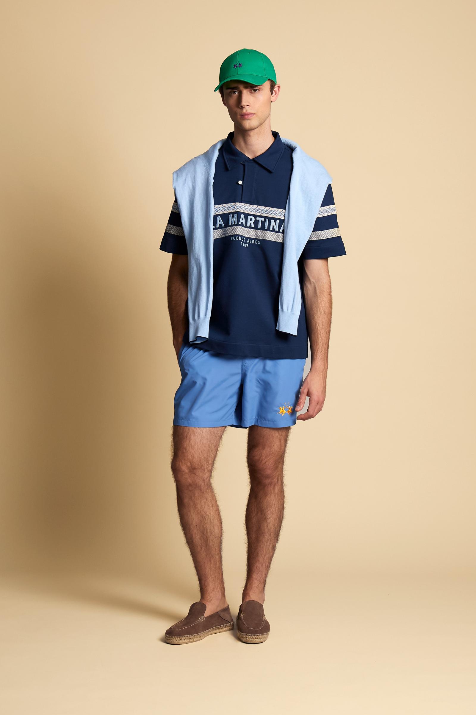 Short-sleeve polo in heavy cotton jersey with a compact structure and substantial hand feel. Contemporary fit with relaxed volume and slightly dropped shoulders. Classic collar with visible placket and bold horizontal band with geometric multicolor tapes. Raised “La Martina” embroidery on the chest and contrasting 3D logo on the back. - Navy                                                                                                                                                                         