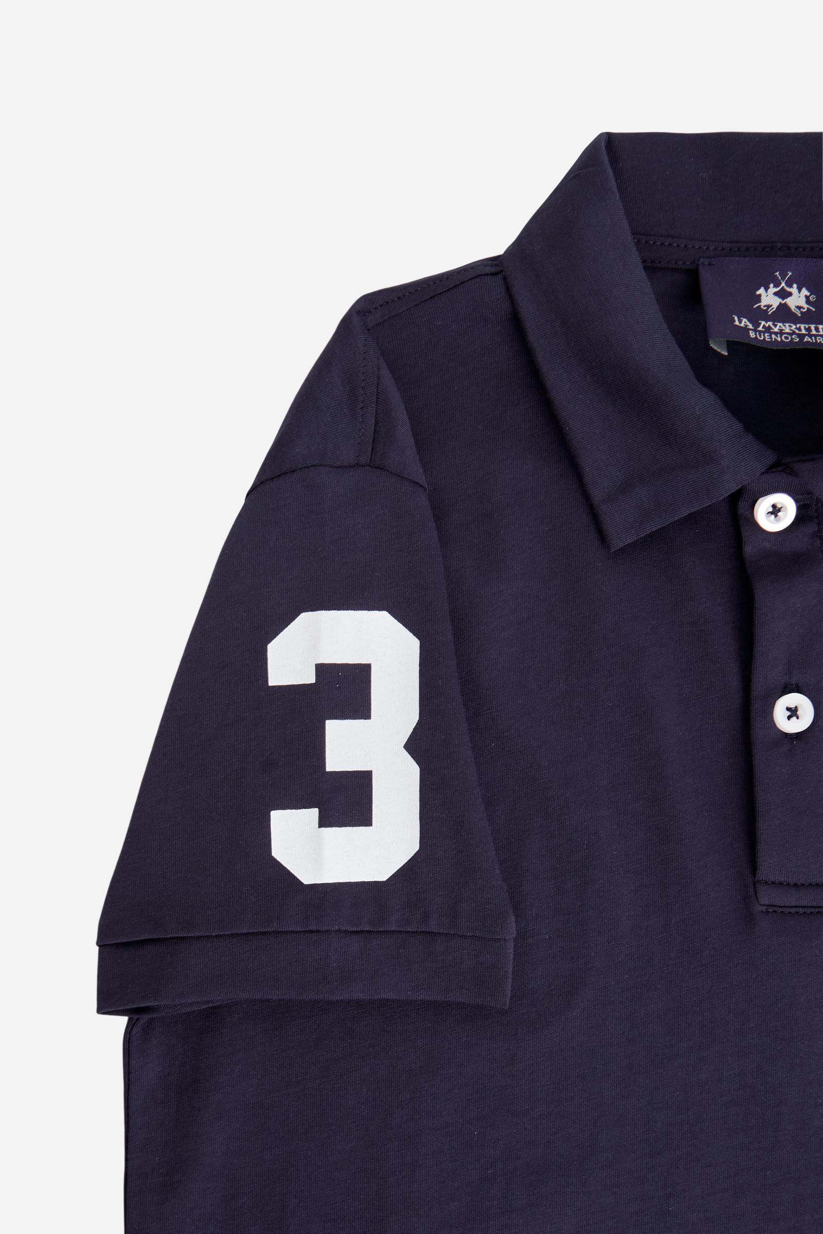 Short-sleeved polo shirt for boys made from soft 100% cotton jersey. The style features a regular fit, two-button front opening and collar in the same fabric. The number “3” printed on the right sleeve, the brand lettering under the collar and the small embroidered logo on the chest add contrast details with an iconic and sporty character. - Navy