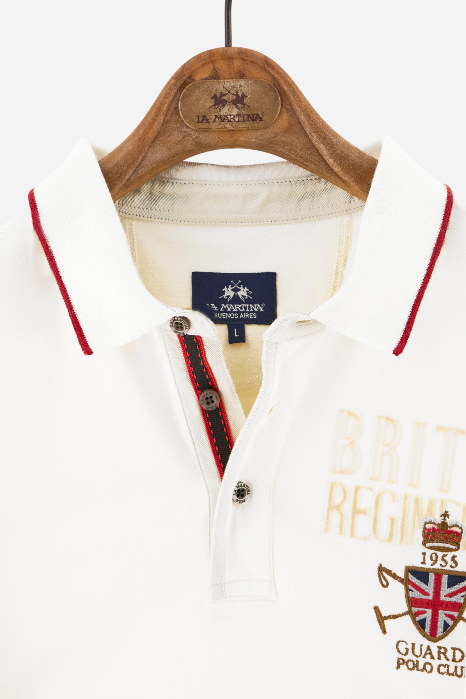 Short-sleeve polo shirt from the Guards capsule, made of high-quality stretch cotton piqué. Ribbed collar and cuffs in matching tone, with contrast striped detail on the collar. Three-button personalized placket. Multicolor graphics, patches, and lettering celebrate the British regiment, applied to chest and sleeves. Brand logo embroidered in contrast on the left sleeve. Regular straight fit. Model wears size L. - Pristine
