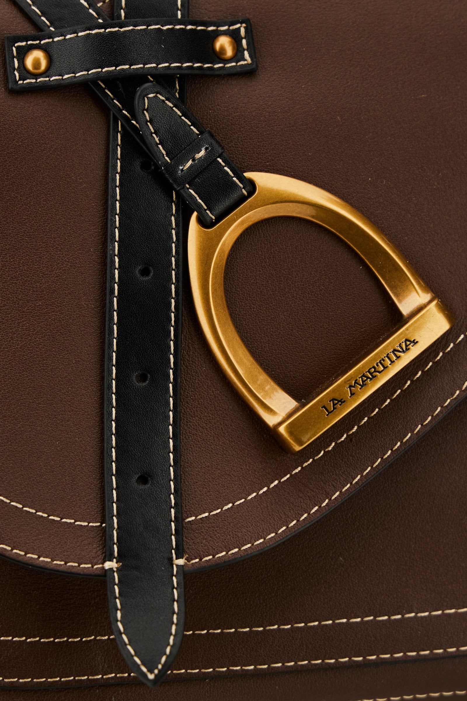 Elegant women's tote in full-grain leather with semi-rigid structure, gold-tone stirrup detail, double handles, adjustable strap, and roomy, secure interior. - Sienna/Black