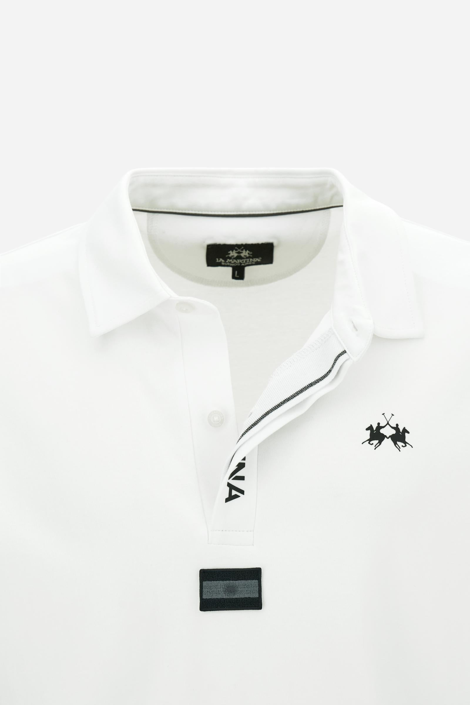 Premium men’s long-sleeve polo shirt in 100% cotton jersey with a smooth, silky texture. Hidden button placket and vertical contrast print. Patches dedicated to the Asociación Argentina de Polo (AAP) on the sleeve and below the opening. Small semi-transparent contrasting logo printed on the chest. Regular fit. The model wears size L. - Optic White