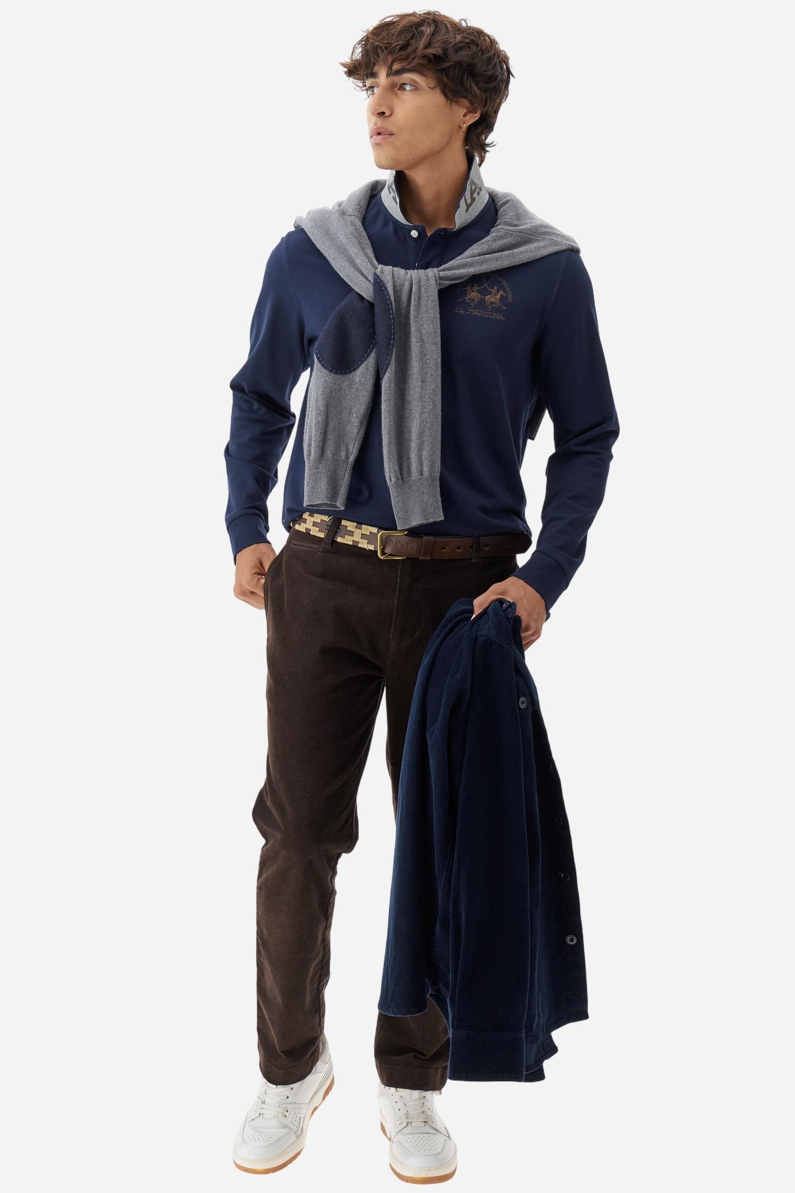 Men's long-sleeved solid colour polo shirt. Made of high-quality stretch Piqué. The collar and cuffs are in solid colour ribbing. The undercollar features a print of the iconic La Martina lettering in a contrasting colour. Featuring a logo embroidered on the chest in a contrasting colour. On the back at the bottom, the guarantee label typical of the brand's iconic models is applied. Regular fit. The model is wearing a size L. - Navy