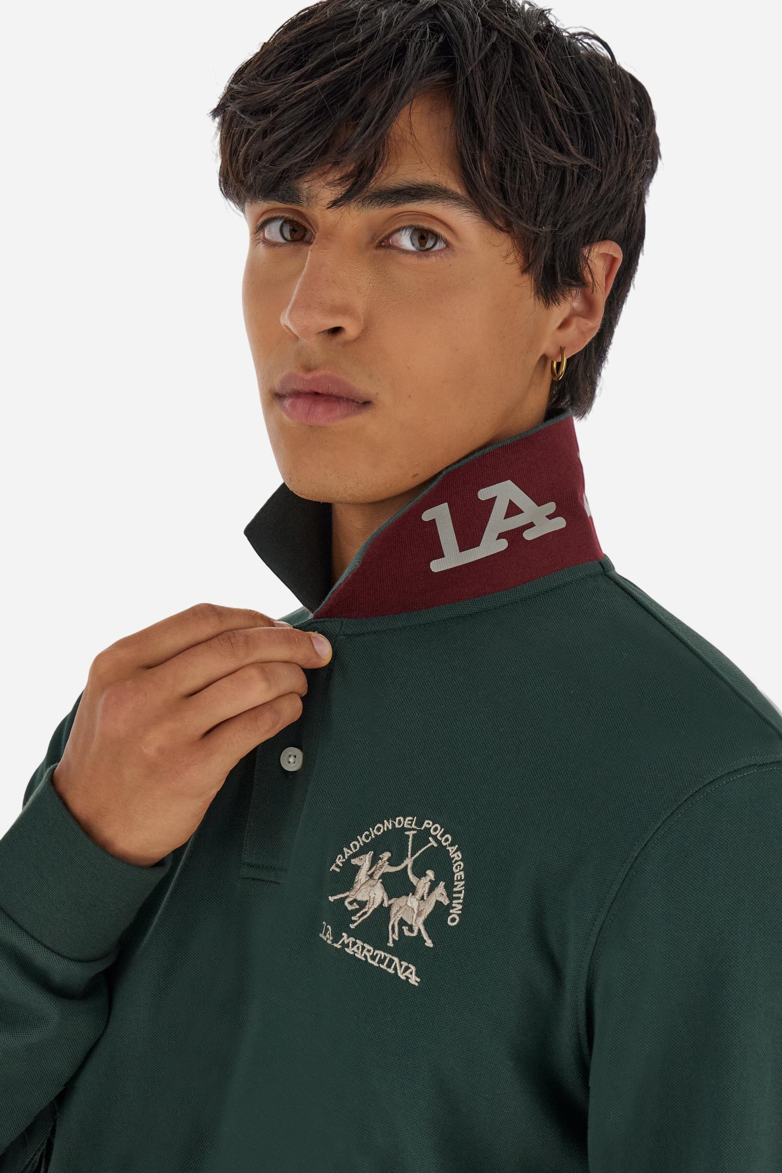 Men's long-sleeved solid colour polo shirt. Made of high-quality stretch Piqué. The collar and cuffs are in solid colour ribbing. The undercollar features a print of the iconic La Martina lettering in a contrasting colour. Featuring a logo embroidered on the chest in a contrasting colour. On the back at the bottom, the guarantee label typical of the brand's iconic models is applied. Regular fit. The model is wearing a size L. - Sycamore