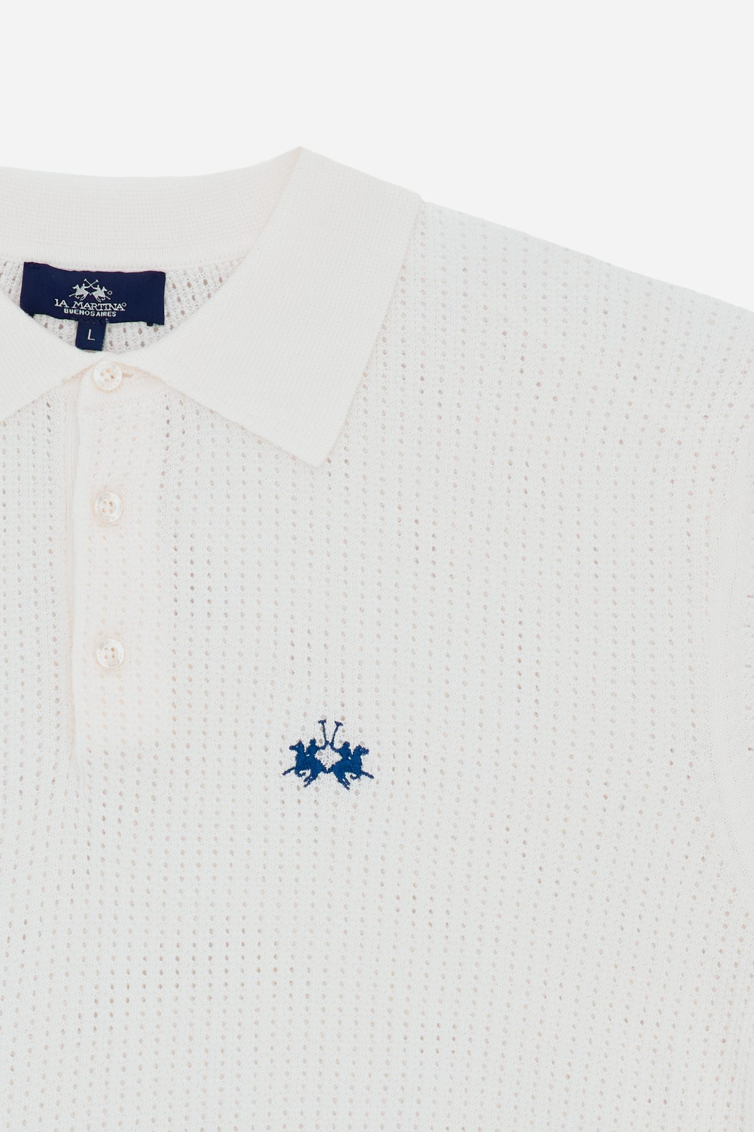 Elevate your summer wardrobe with this perforated knit polo, a piece that blends the classic style of a polo with a contemporary and refined texture. Designed to provide maximum freshness, it is the ideal choice for those seeking a sophisticated look without sacrificing comfort during the warmer days. - Optic White