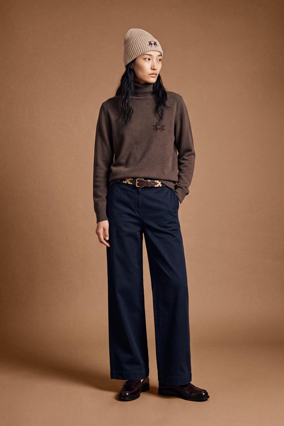 Women's lambswool turtleneck sweater with a soft, ribbed collar, fitted bust, ribbed cuffs and hem, and subtle embroidered logo for a clean, elegant look. - Hot Fudge