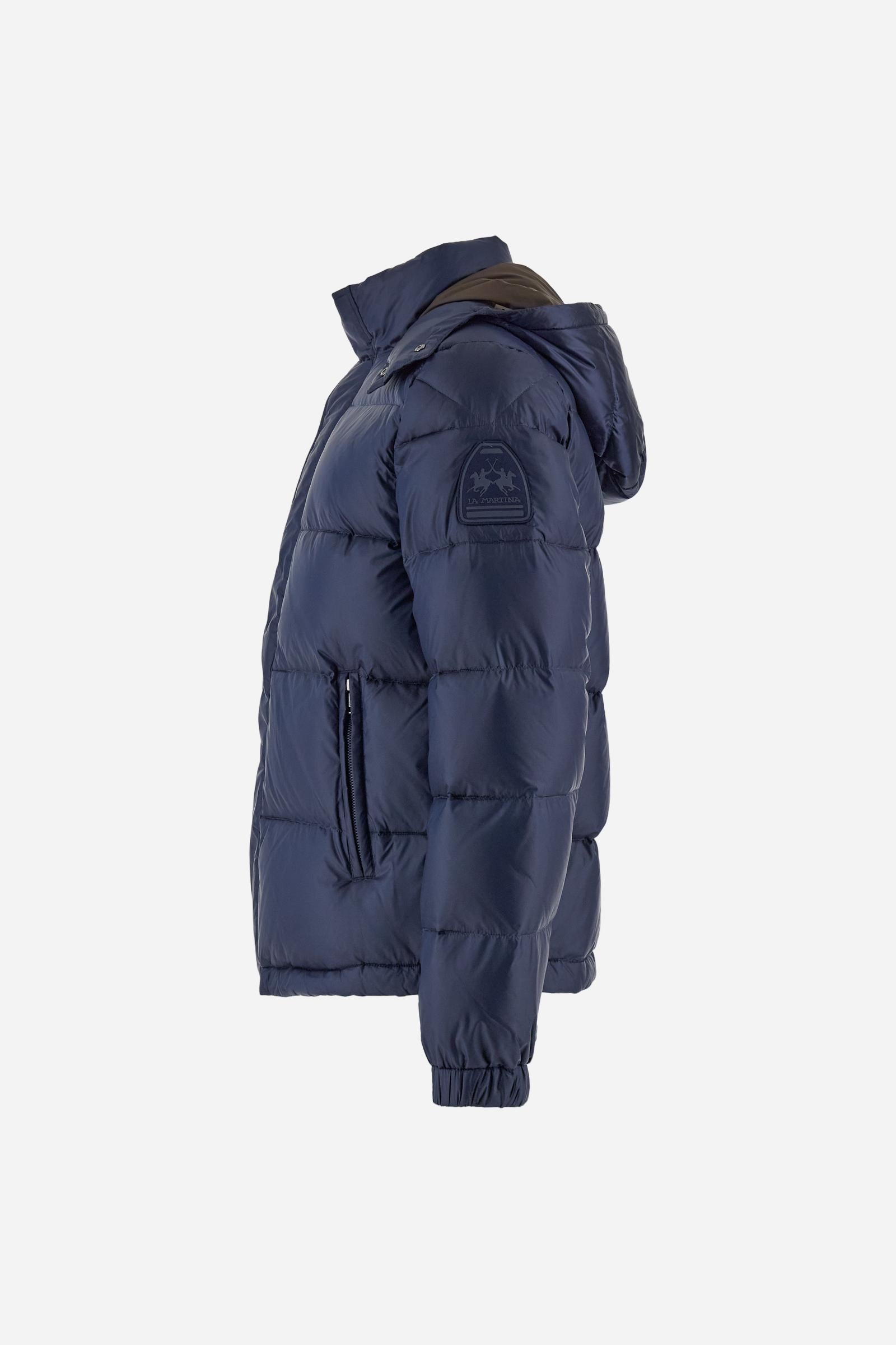 Men’s padded bomber jacket with detachable hood. Made of solid iridescent nylon with contrast lining. Equipped with two practical inner braces for extra comfort. Double customized zip front closure with inner placket featuring contrast Polo Player print, closed with metal snap buttons. Two vertical zipped pockets on the front. Hood with contrast lining and adjustable elastic drawstring. Bold Polo Player graphics printed inside. Regular fit for comfortable movement without bulk. Model wears size L. - Navy