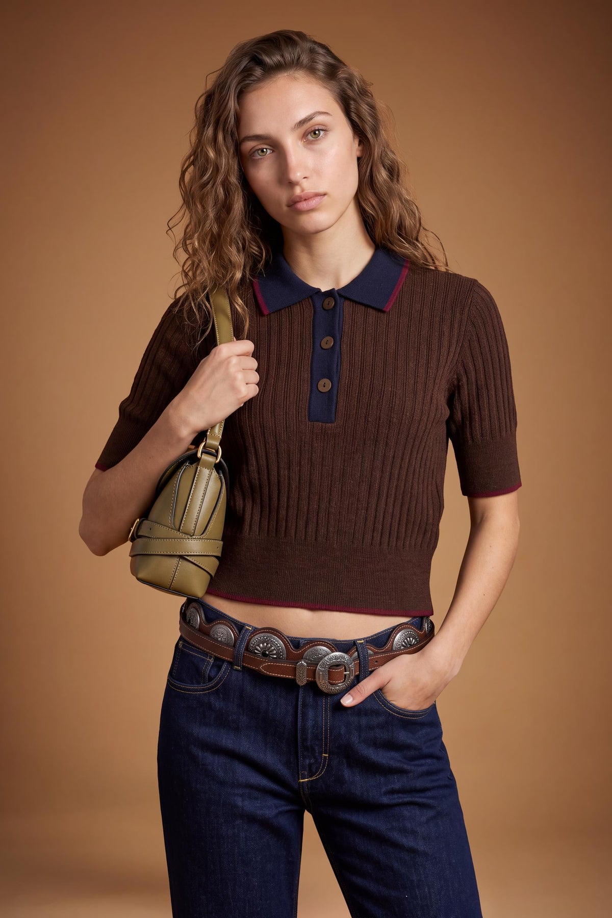 Slim-fit women's short-sleeve polo made from soft lambswool blend with vertical ribbing, ribbed collar, cuffs, and hem, featuring contrasting trims and a three-button front. - Dark Brown