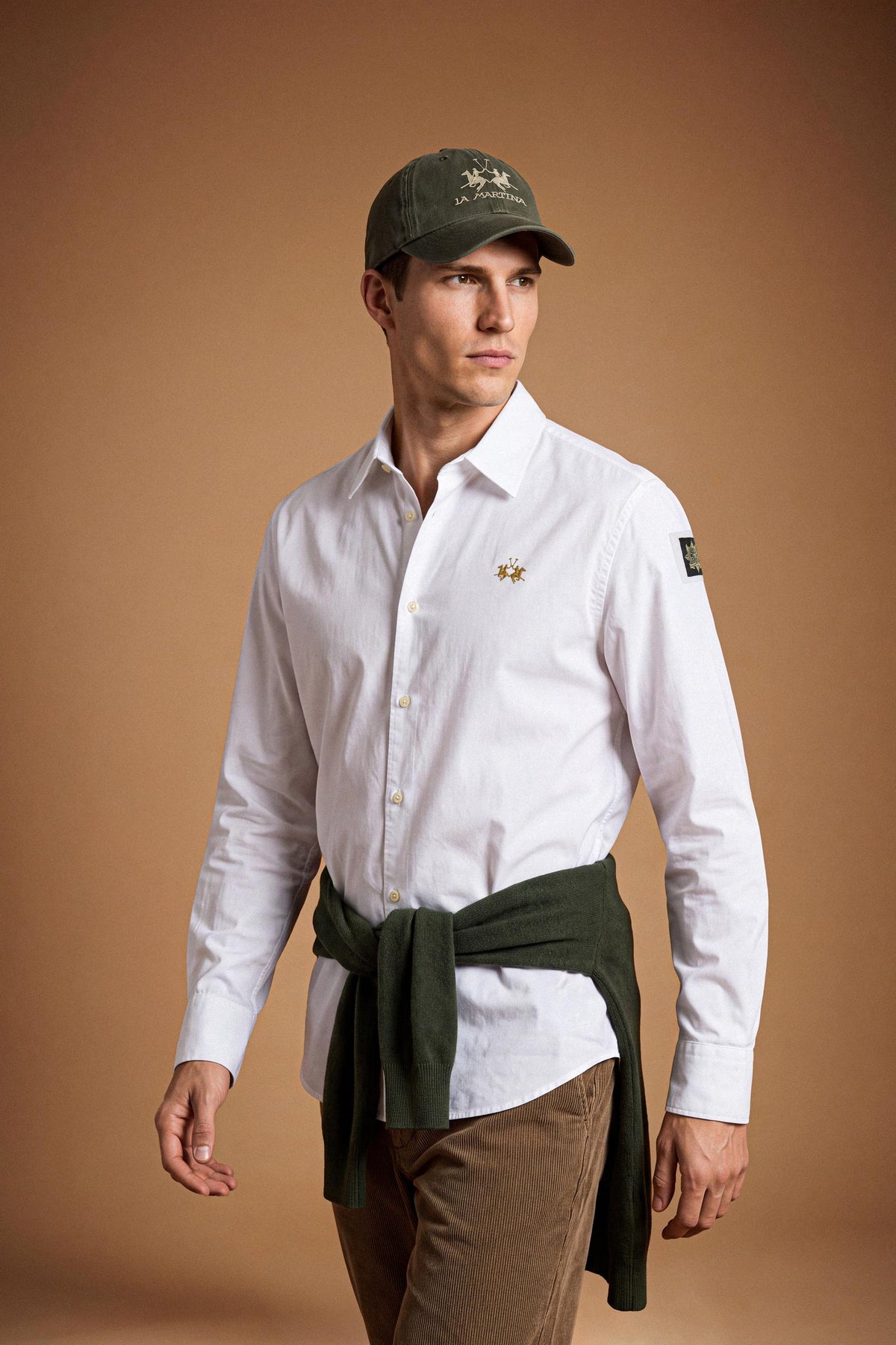Men’s long-sleeve 100% cotton Oxford shirt with classic collar, button closure, embroidered details, red contrast stitching, and a comfortable regular fit with rounded hem. - Optic White