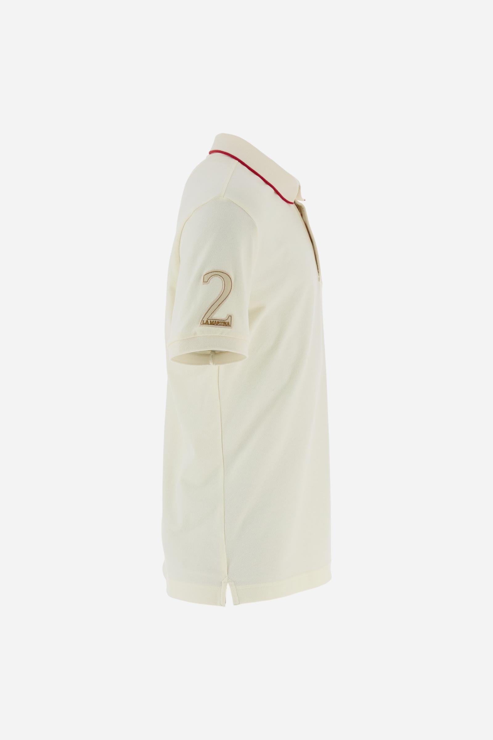 Short-sleeve polo shirt from the Guards capsule, made of high-quality stretch cotton piqué. Ribbed collar and cuffs in matching tone, with contrast striped detail on the collar. Three-button personalized placket. Multicolor graphics, patches, and lettering celebrate the British regiment, applied to chest and sleeves. Brand logo embroidered in contrast on the left sleeve. Regular straight fit. Model wears size L. - Pristine