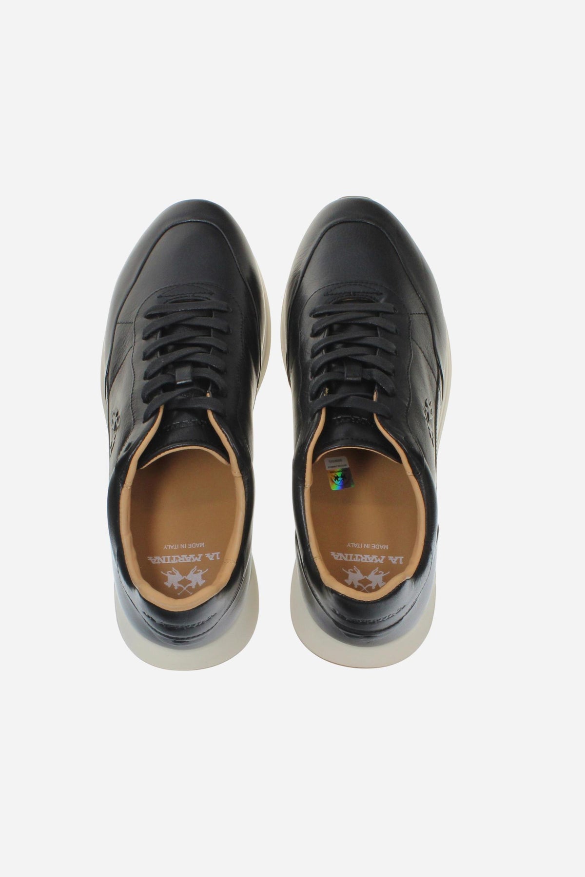 Men's sneaker crafted from soft vegetable-tanned leather with handcrafted stitching, embossed logo, two-tone rubber PU sole, and leather-colored lining. Made in Italy. - Black