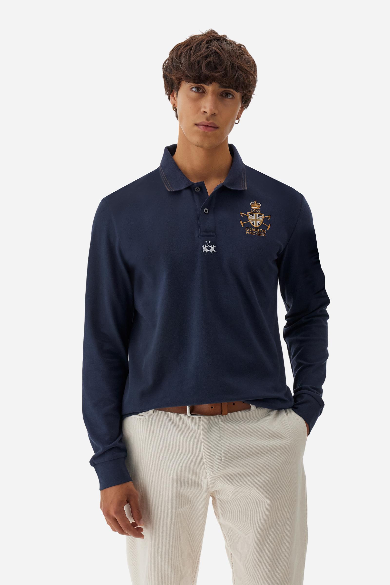Long-sleeve polo shirt in stretch cotton jersey, soft and breathable. Ribbed collar with contrast striped edge and inner tartan ribbon. A colorful embroidered crest enriches the chest, complemented by a tonal embroidered logo under the placket with two personalized buttons. Regular fit for a versatile, timeless look. Model wears size L. - Navy