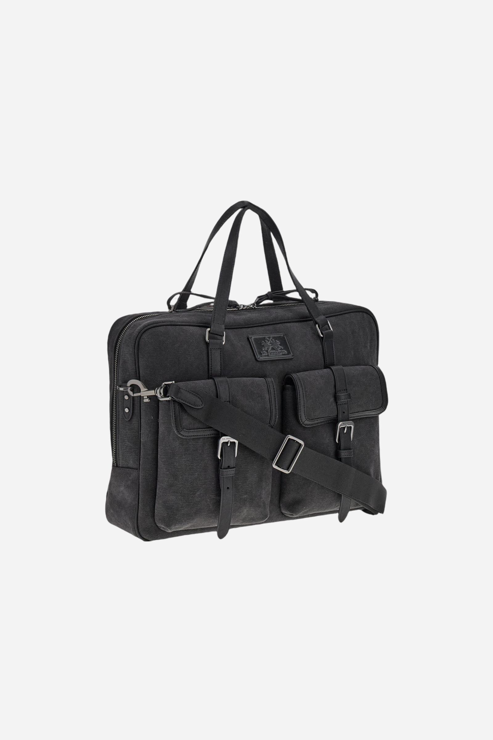 Semi-rigid work bag in washed canvas with smooth leather details, practical and roomy, ideal for work and daily commuting. Closed with a top zip, it includes a detachable shoulder strap and multiple pockets for added functionality. The hot-stamped logo on the leather tag completes the model. Dimensions:40 x 31 x 9 - Black